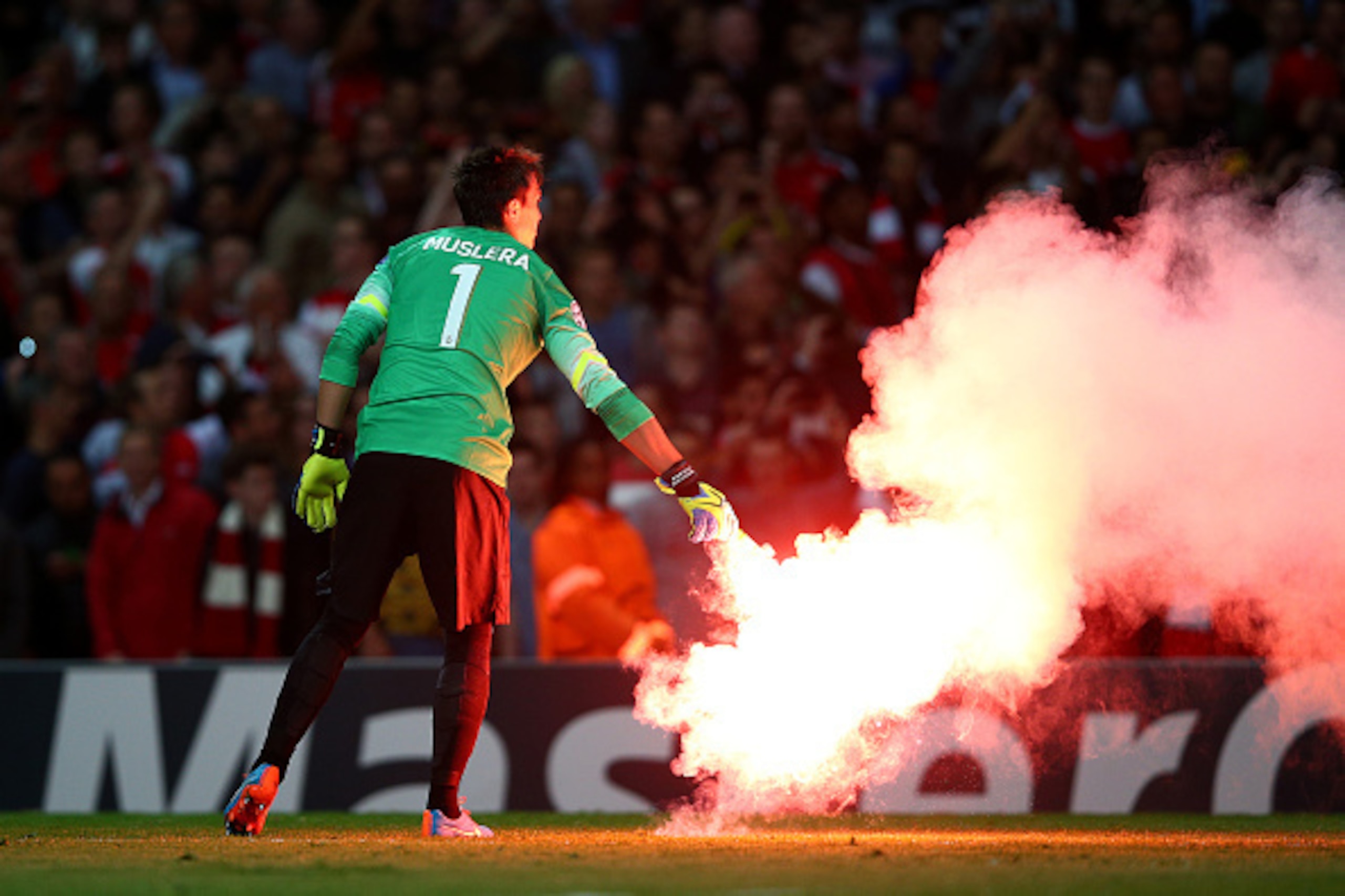 LONDON, ENGLAND - OCTOBER 01:  Fernando Muslera of Galatasaray AS carries a flare off the pitch during the UEFA Champions League group D match between Arsenal FC and Galatasaray AS at Emirates Stadium on October 1, 2014 in London, United Kingdom.  (Photo 