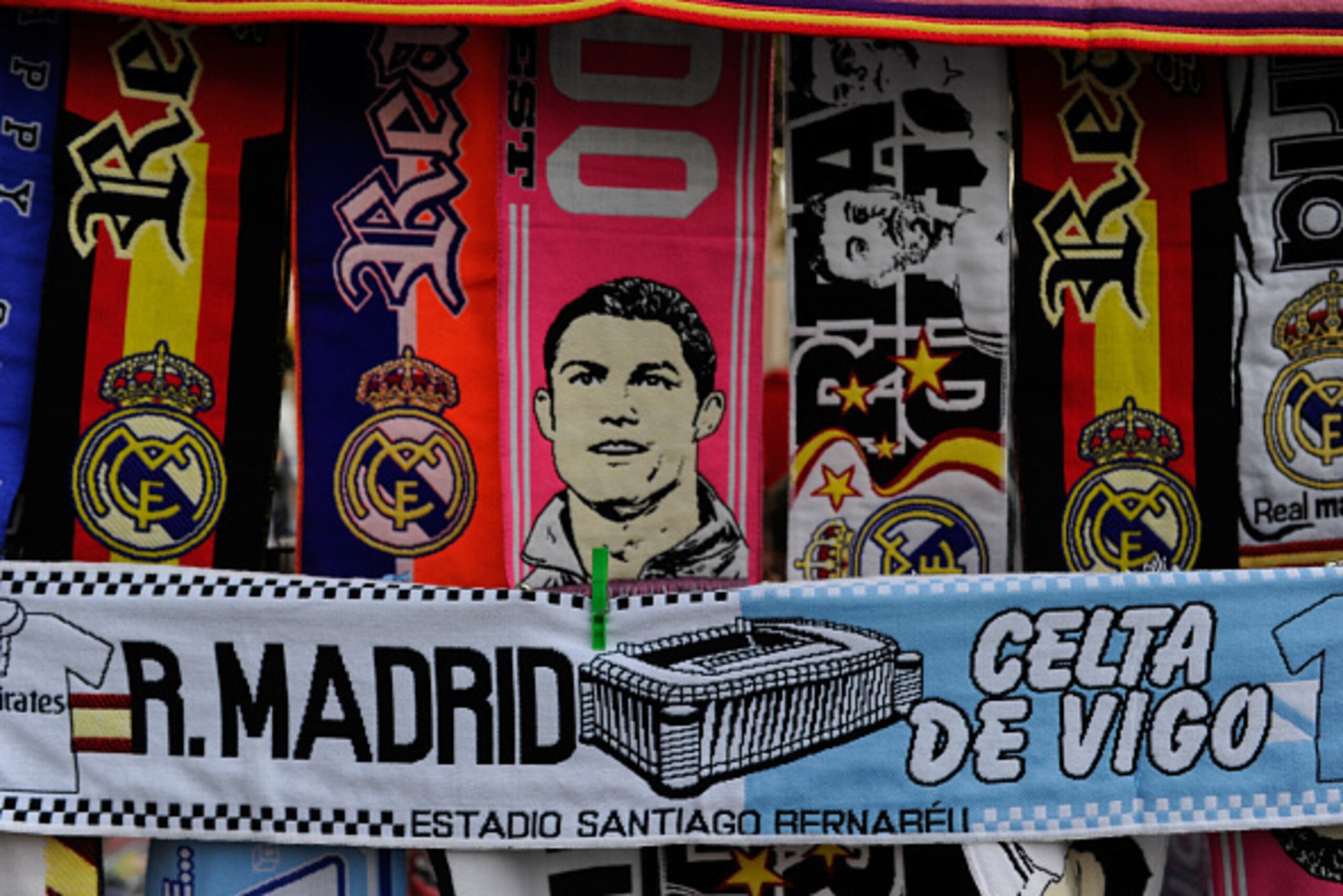 MADRID, SPAIN - DECEMBER 06: A Real Macrid v Celta Vigo scarf is for sale at a stall outside the Santiago Bernabeu stadium prior to the La Liga match between Real Madrid CF and Celta Vigo at Estadio Santiago Bernabeu on December 6, 2014 in Madrid, Spain. MADRID, SPAIN - DECEMBER 06: A Real Macrid v Celta Vigo scarf is for sale at a stall outside the Santiago Bernabeu stadium prior to the La Liga match between Real Madrid CF and Celta Vigo at Estadio Santiago Bernabeu on December 6, 2014 in Madrid, Spain.
