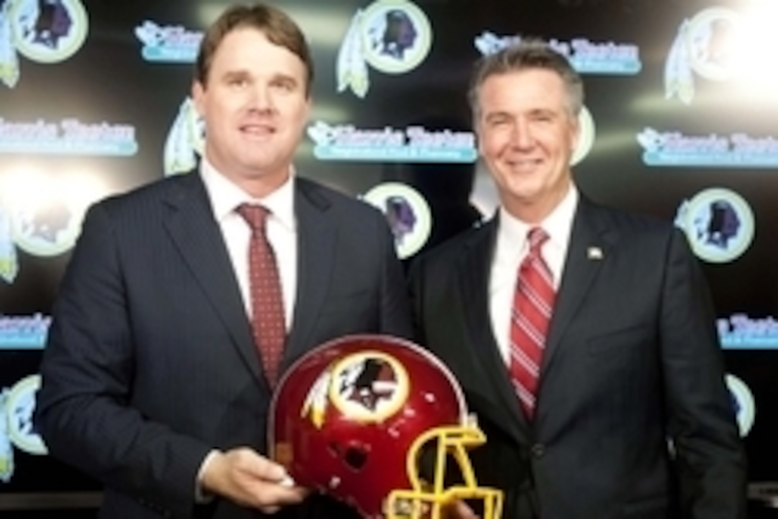 Jan 9, 2014; Ashburn, VA, USA; Washington Redskins head coach Jay Gruden and general manager Bruce Allen pose for a photo after a press conferences at Redskins Park Team Auditorium. Mandatory Credit: Brad Mills-USA TODAY Sports
