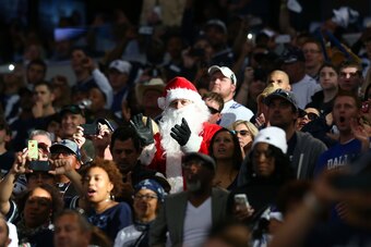 ARLINGTON, TX - NOVEMBER 27:  A fan dressed as Santa Claus claps before the start of the Thanksgiving Day game between the Philadelphia Eagles and the Dallas Cowboys at AT&T Stadium on November 27, 2014 in Arlington, Texas.  (Photo by Ronald Martinez/Gett