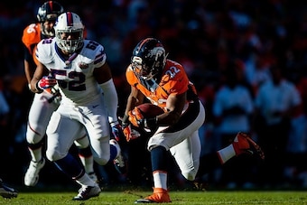 DENVER, CO - DECEMBER 7:  Running back C.J. Anderson #22 of the Denver Broncos rushes against the Buffalo Bills during a game at Sports Authority Field at Mile High on December 7, 2014 in Denver, Colorado.  (Photo by Dustin Bradford/Getty Images)
