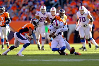 DENVER, CO - DECEMBER 7:  Cornerback Bradley Roby #29 of the Denver Broncos forces a fumble by wide receiver Sammy Watkins #14 of the Buffalo Bills as Rahim Moore #26 helps recover the fumble during the first quarter at Sports Authority Field Field at Mil