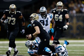 NEW ORLEANS, LA - DECEMBER 07:   Drew Brees #9 of the New Orleans Saints is sacked by Carolina Panthers defenders during the first quarter at Mercedes-Benz Superdome on December 7, 2014 in New Orleans, Louisiana.  (Photo by Sean Gardner/Getty Images)