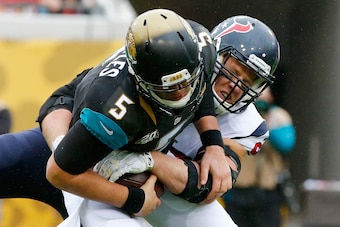 JACKSONVILLE, FL - DECEMBER 07:  Blake Bortles #5 of the Jacksonville Jaguars is sacked by  J.J. Watt #99 of the Houston Texans during the game at EverBank Field on December 7, 2014 in Jacksonville, Florida.  (Photo by Sam Greenwood/Getty Images)