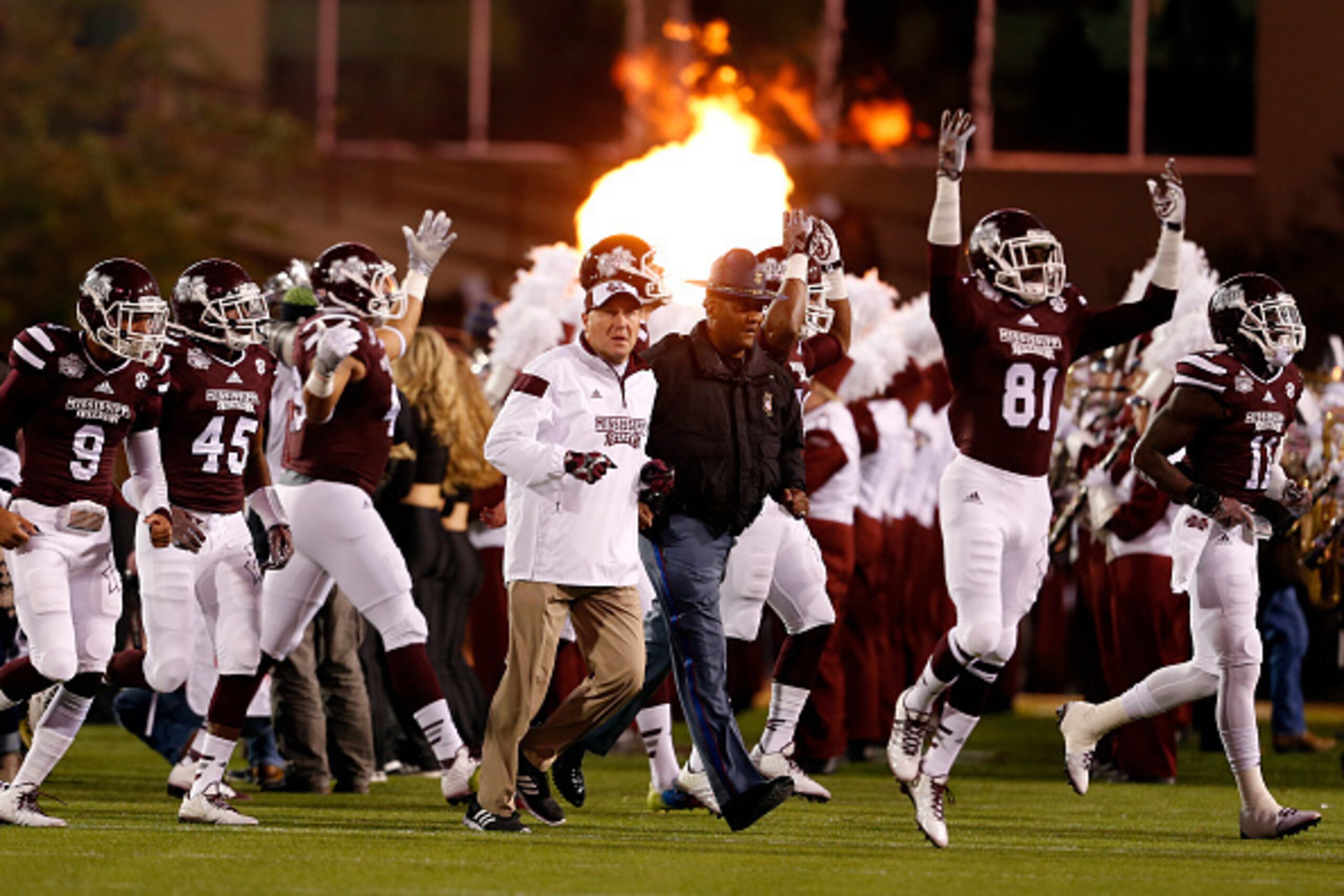 STARKVILLE, MS - NOVEMBER 1:  Coach Dan Mullen of the Mississippi State Bulldogs leads his team onto the field to take on the Arkansas Razorbacks in the first half at Davis Wade Stadium on November 1, 2014  in Starkville, Mississippi. (Photo by Butch Dill