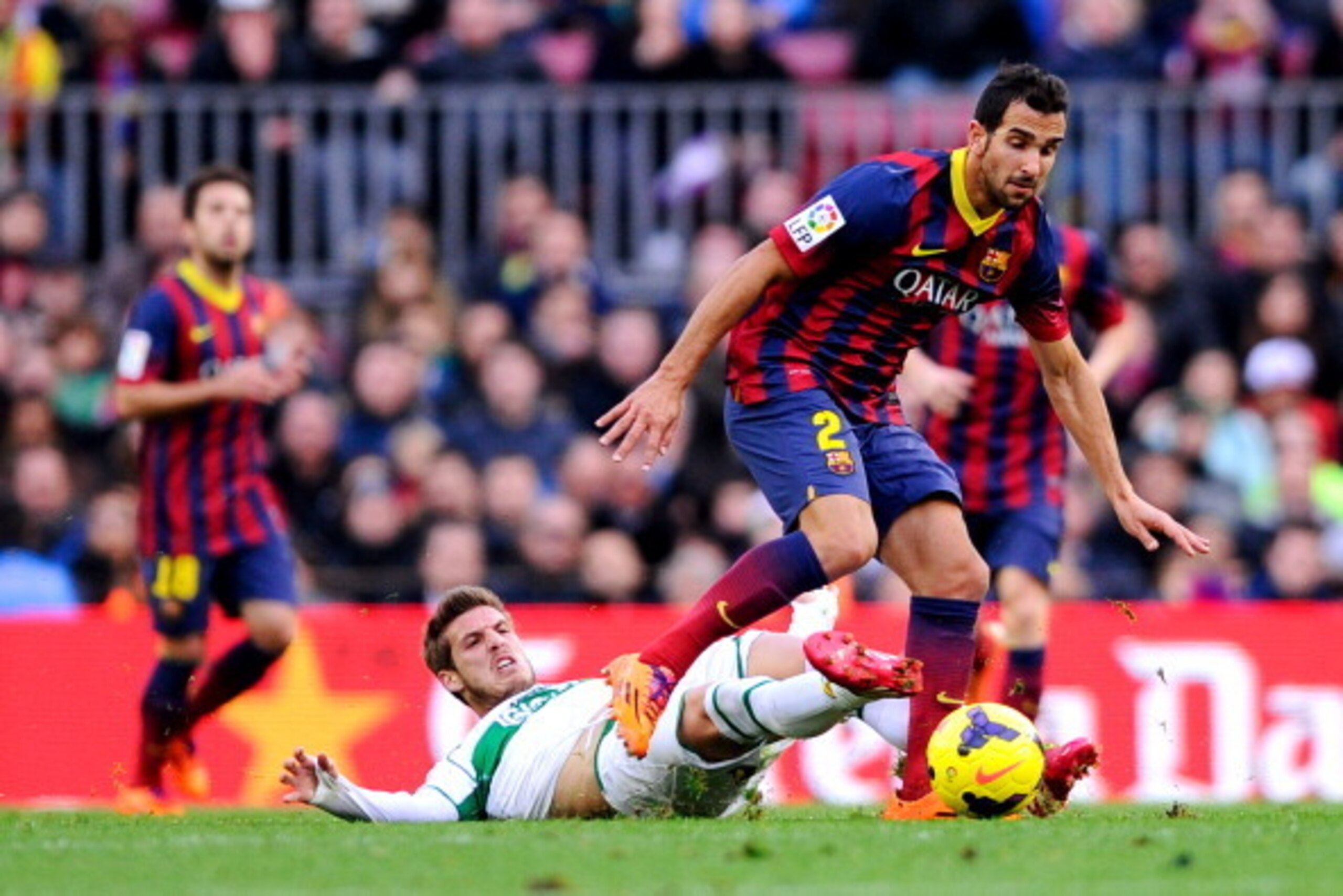 BARCELONA, SPAIN - JANUARY 05:  Martin Montoya of FC Barcelona duels for the ball with Ruben Perez of Elche FC during the La Liga match between FC Barcelona and Elche FC at Camp Nou on January 5, 2014 in Barcelona, Spain.  (Photo by David Ramos/Getty Imag