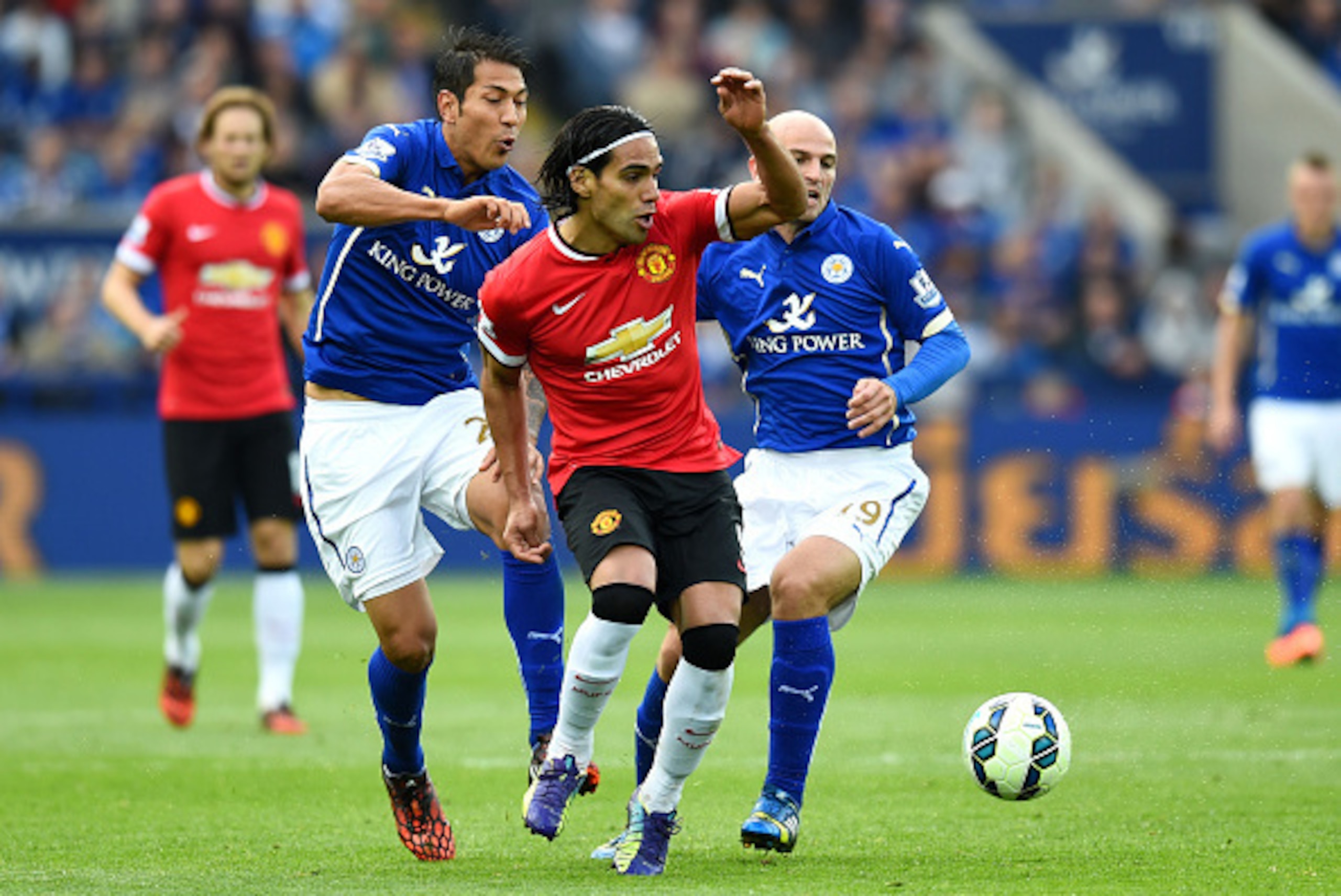 LEICESTER, ENGLAND - SEPTEMBER 21:  Radamel Falcao Garcia of Manchester United is challenged by Leonardo Ulloa (L) of Leicester City and Esteban Cambiasso (R) of Leicester City during the Barclays Premier League match between Leicester City and Manchester