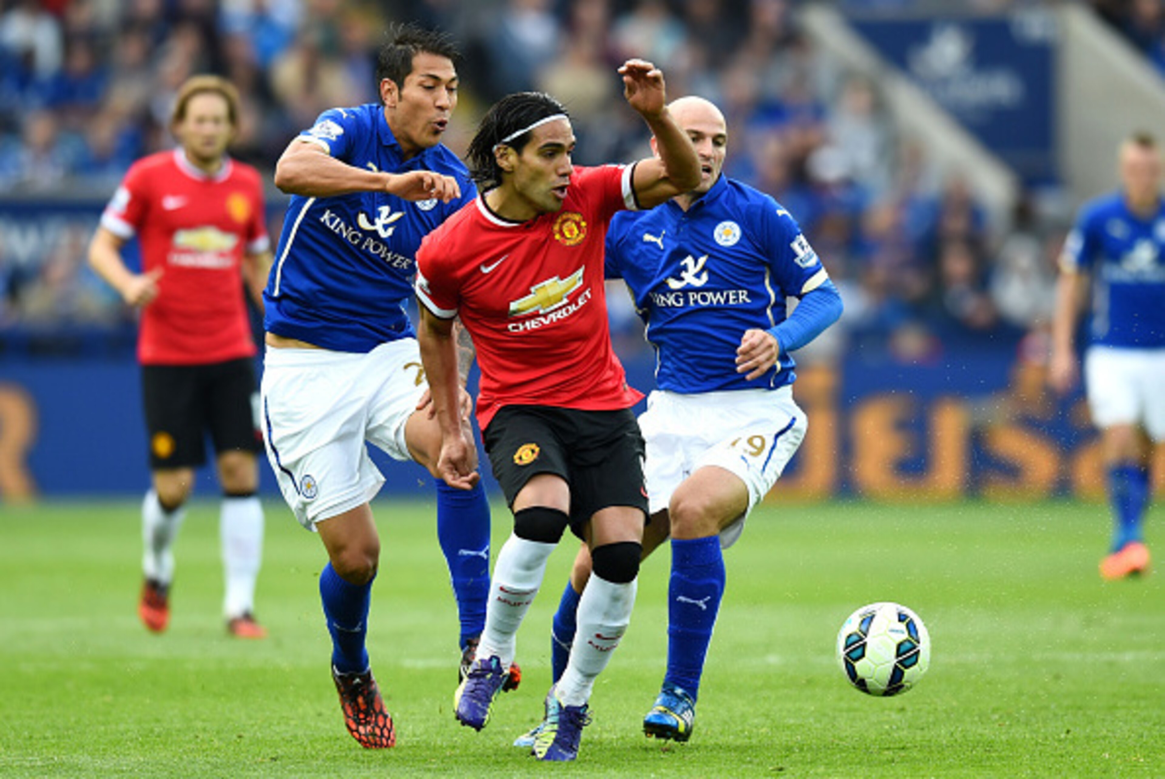 LEICESTER, ENGLAND - SEPTEMBER 21:  Radamel Falcao Garcia of Manchester United is challenged by Leonardo Ulloa (L) of Leicester City and Esteban Cambiasso (R) of Leicester City during the Barclays Premier League match between Leicester City and Manchester
