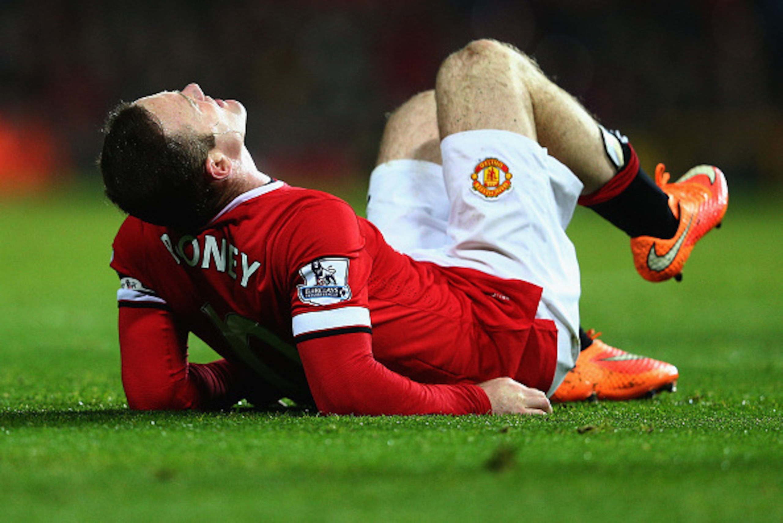 MANCHESTER, ENGLAND - NOVEMBER 29: Wayne Rooney of Manchester United lies injured during the Barclays Premier League match between Manchester United and Hull City at Old Trafford on November 29, 2014 in Manchester, England.  (Photo by Clive Mason/Getty Im