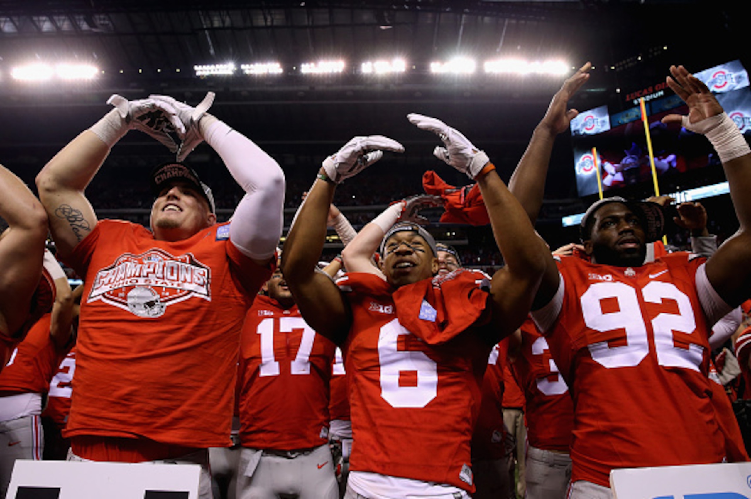 INDIANAPOLIS, IN - DECEMBER 06:  Evan Spencer #6 (C), Adolphus Washington #92 (R) and the Ohio State Buckeyes celebrate after they defeated the Wisconsin Badgers 59-0 in the Big Ten Championship at Lucas Oil Stadium on December 6, 2014 in Indianapolis, In