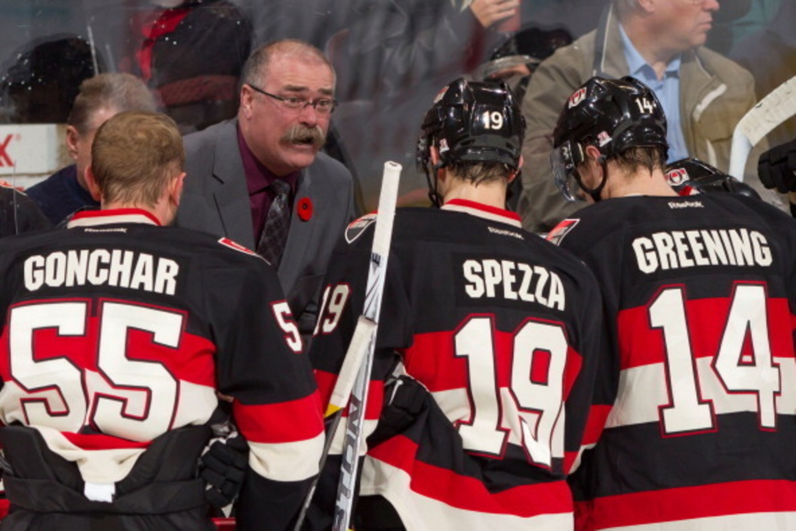OTTAWA, CANADA - NOVEMBER 4: Head coach Paul MacLean of the Ottawa Senators talks to Sergei Gonchar #55, Jason Spezza #19 and Colin Greening #14 of the Ottawa Senators during a time-out during an NHL game against the Montreal Canadiens at Scotiabank Place