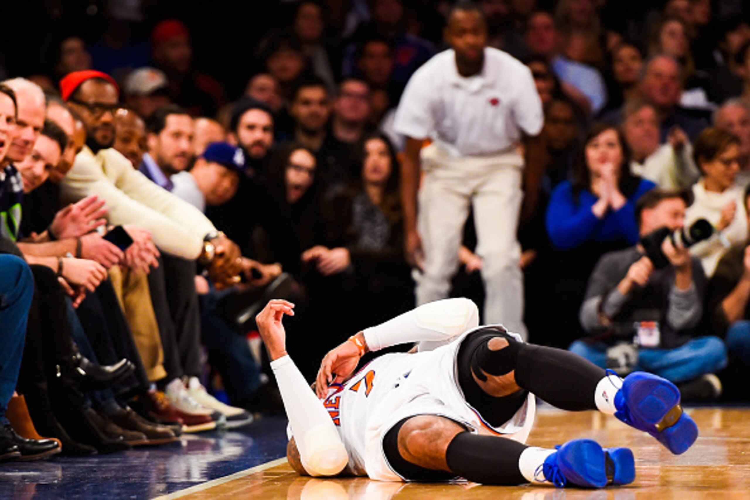 NEW YORK, NY - DECEMBER 07: Carmelo Anthony #7 of the New York Knicks rolls over after falling down in the second half during a game against the Portland Trail Blazers at Madison Square Garden on December 7, 2014 in New York City. NOTE TO USER: User expre