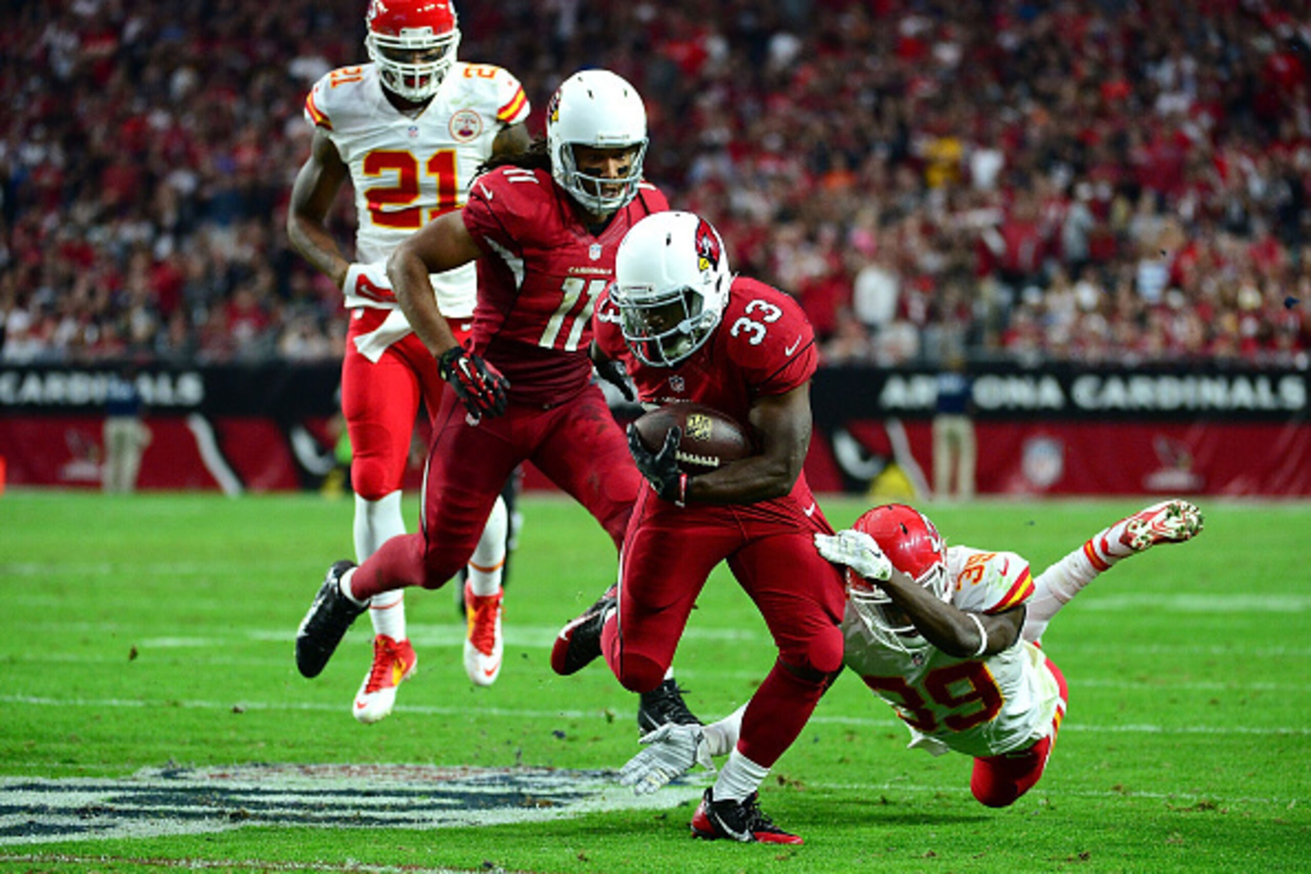 GLENDALE, AZ - DECEMBER 07: Running back Kerwynn Williams #33 of the Arizona Cardinals slips by free safety Husain Abdullah #39 of the Kansas City Chiefs in the second half of the the NFL game at University of Phoenix Stadium on December 7, 2014 in Glenda