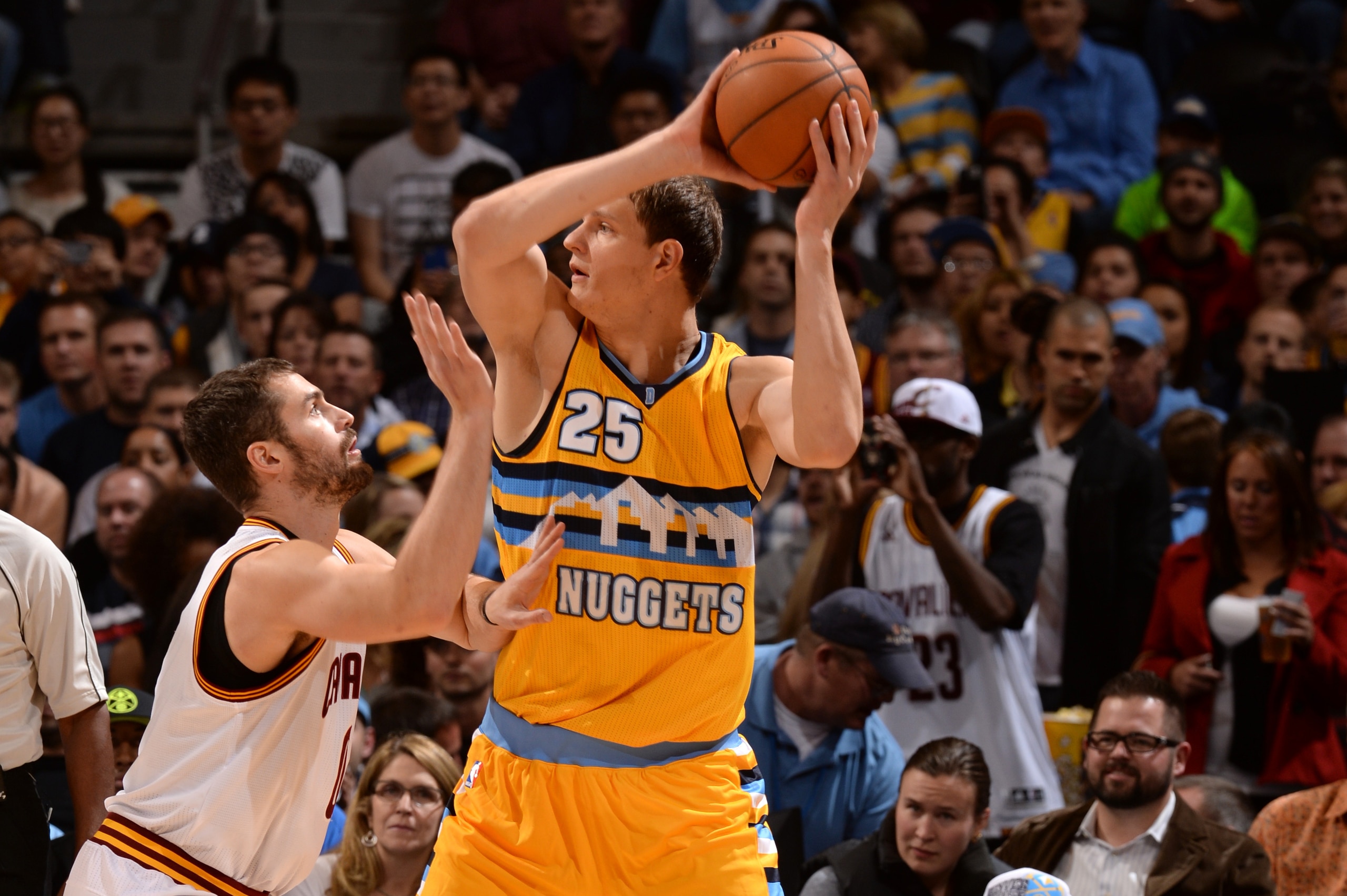 DENVER, CO - NOVEMBER 7:  Timofey Mozgov #25 of the Denver Nuggets handles the ball against Kevin Love #0 of the Cleveland Cavaliers on November 7, 2014 at the Pepsi Center in Denver, Colorado. NOTE TO USER: User expressly acknowledges and agrees that, by