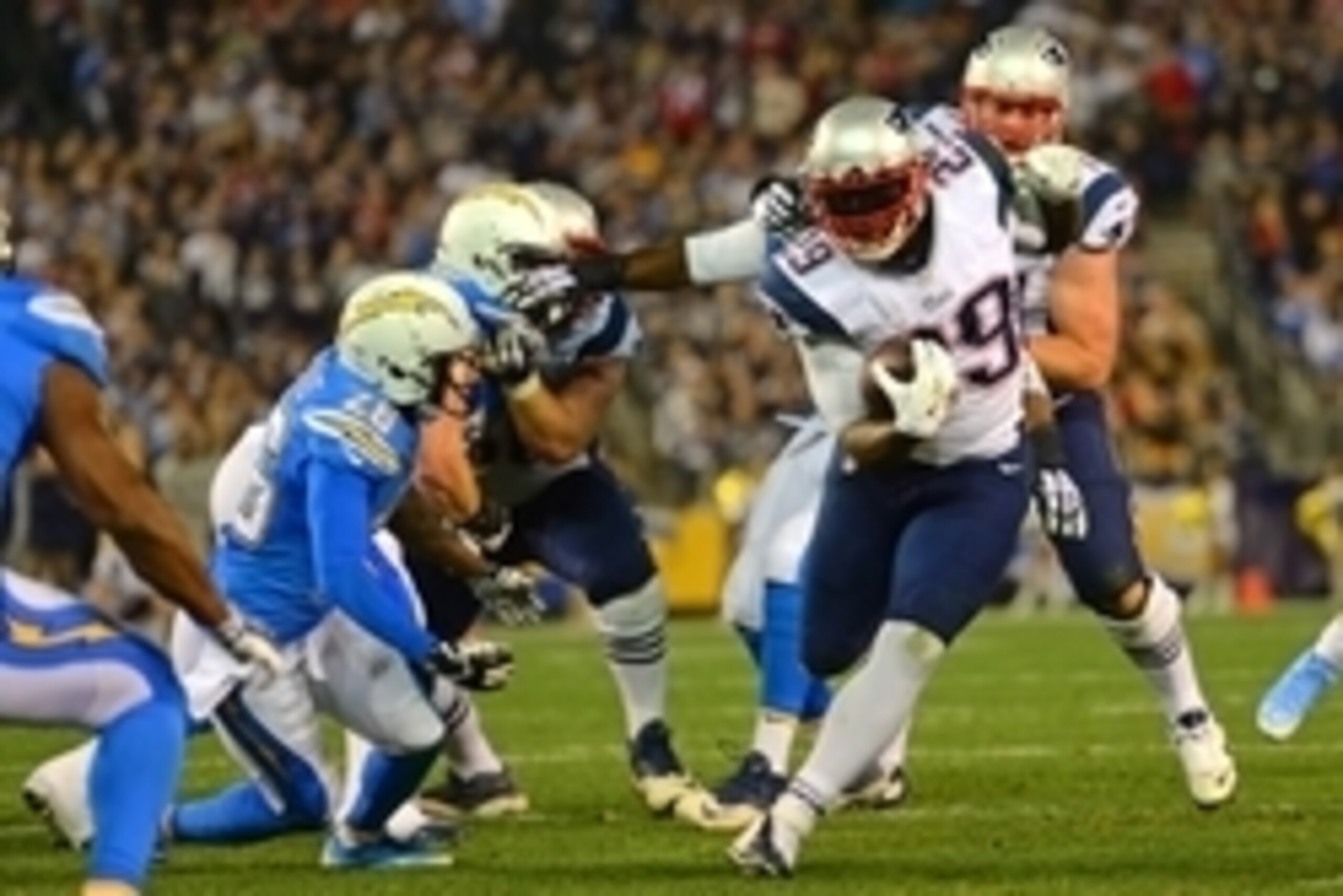 Dec 7, 2014; San Diego, CA, USA; New England Patriots running back LeGarrette Blount (29) runs as San Diego Chargers cornerback Brandon Flowers (26) defends during the first quarter at Qualcomm Stadium. Mandatory Credit: Jake Roth-USA TODAY Sports