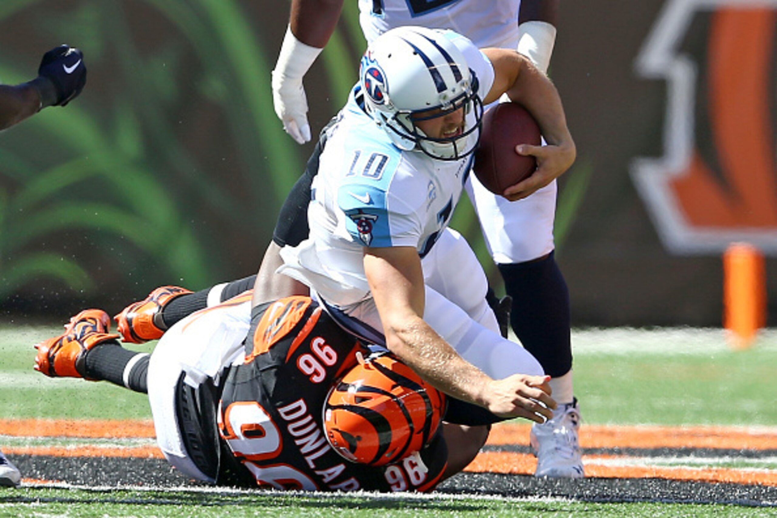 CINCINNATI, OH - SEPTEMBER 21:  Carlos Dunlap #96 of the Cincinnati Bengals sacks Jake Locker #10 of the Tennessee Titans during the third quarter at Paul Brown Stadium on September 21, 2014 in Cincinnati, Ohio. (Photo by Andy Lyons/Getty Images)