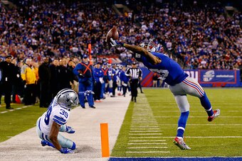 EAST RUTHERFORD, NJ - NOVEMBER 23:  Odell Beckham #13 of the New York Giants scores a touchdown in the second quarter against Brandon Carr #39 of the Dallas Cowboys  at MetLife Stadium on November 23, 2014 in East Rutherford, New Jersey.  (Photo by Al Bel