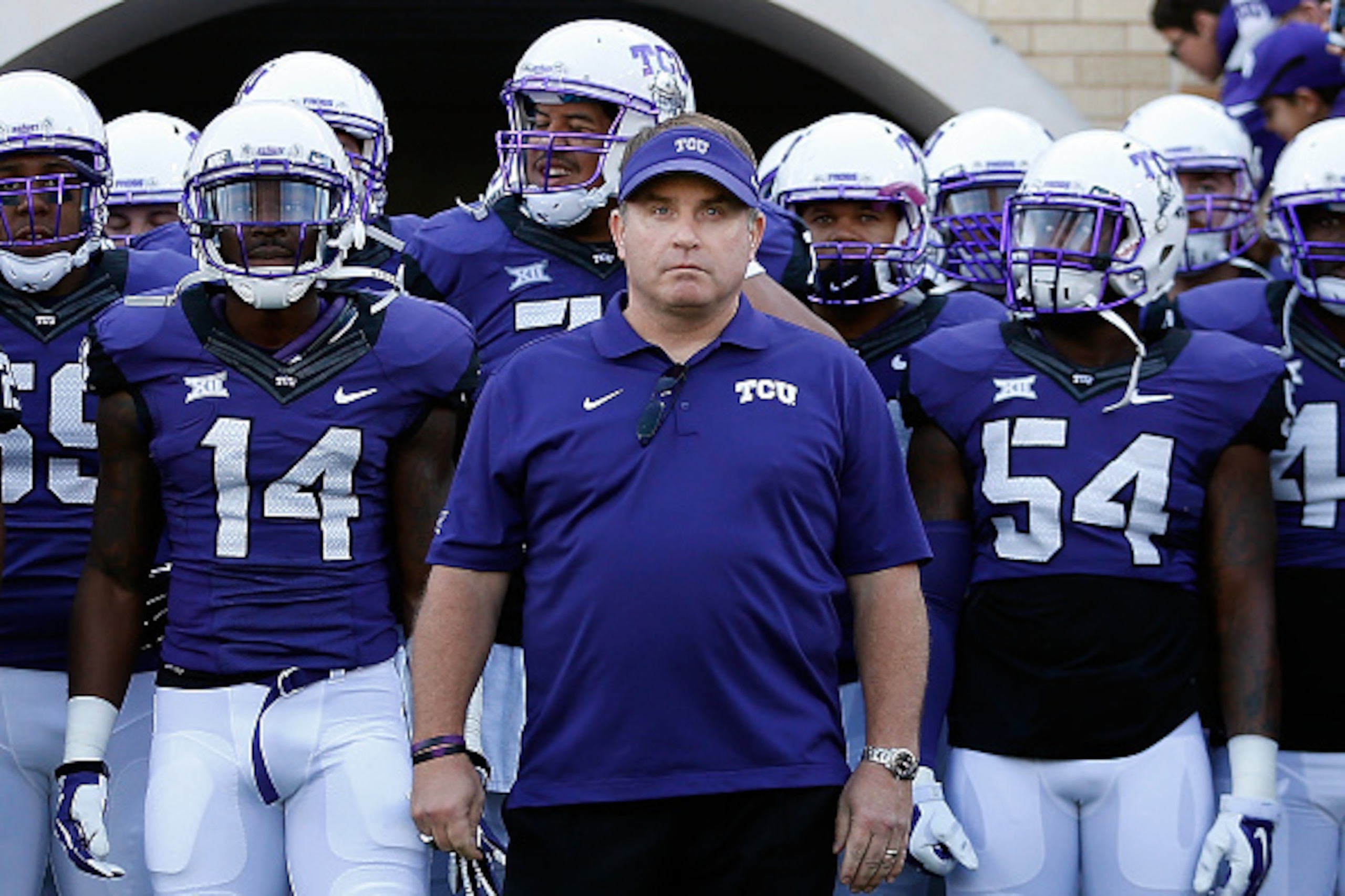 FORT WORTH, TX - DECEMBER 06:  Head coach Gary Patterson of the TCU Horned Frogs leads his team onto the field before the Big 12 college football game against the Iowa State Cyclones at Amon G. Carter Stadium on December 6, 2014 in Fort Worth, Texas. The 