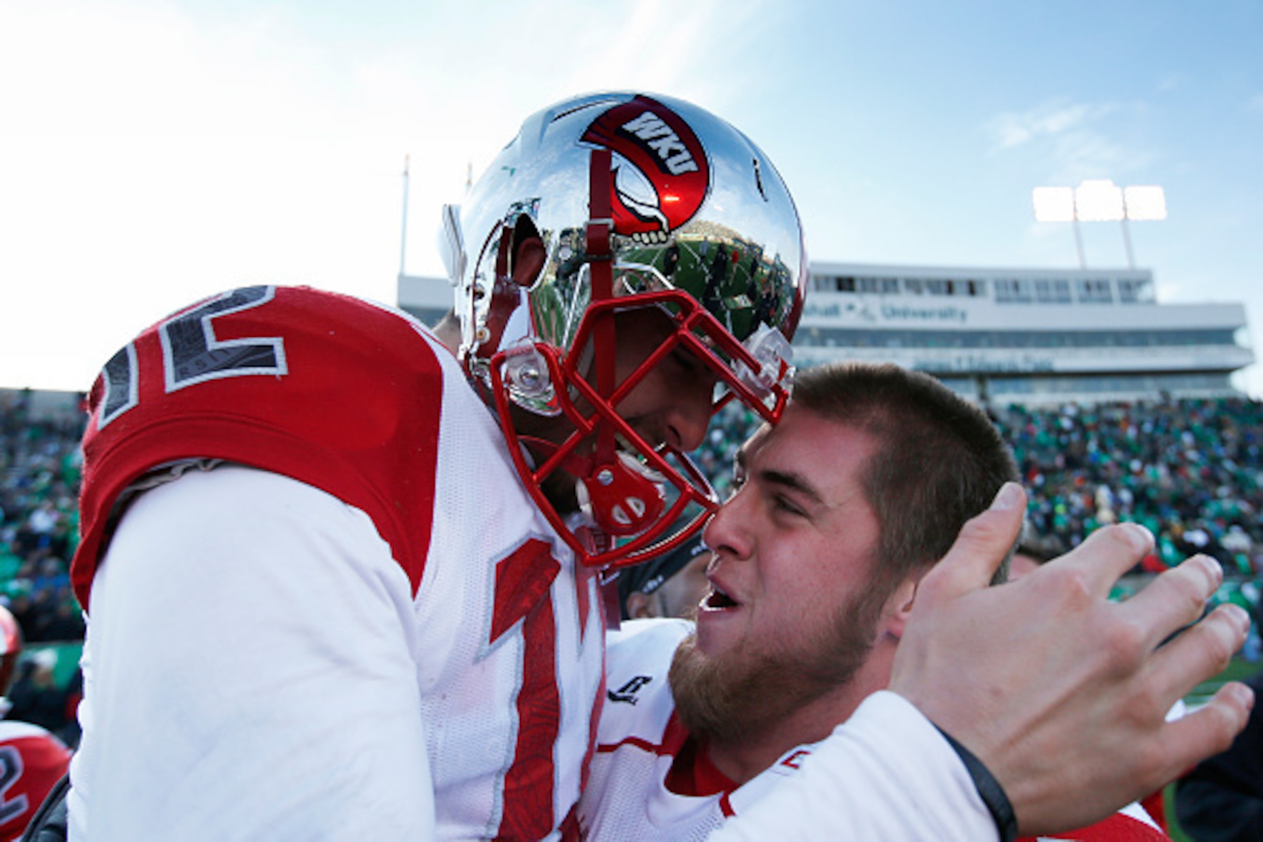 HUNTINGTON, WV - NOVEMBER 28: Brandon Doughty #12 of the Western Kentucky Hilltoppers celebrates after the game against the Marshall Thundering Herd at Joan C. Edwards Stadium on November 28, 2014 in Huntington, West Virginia. Western Kentucky defeated Ma