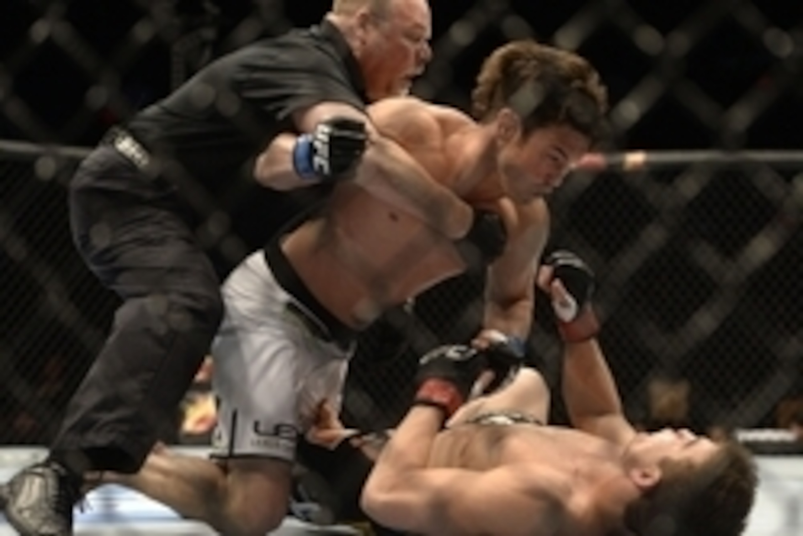 Apr 16, 2014; Quebec City, Quebec, Canada; Sam Stout ( red gloves), London, Ontario, Canada  was defeated by KO/TKO by  KJ Noons (blue gloves) , Kona, HI, USA during their light welterweight bout at Colisee Pepsi. Referee Philippe Chartier stopped the fig