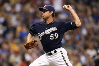 MILWAUKEE, WI - SEPTEMBER 13: Zach Duke #59 of the Milwaukee Brewers delivers a pitch during the seventh inning of their game against the Cincinnati Reds at Miller Park on September 13, 2014 in Milwaukee, Wisconsin. The Reds defeated the Brewers 5-1. (Pho
