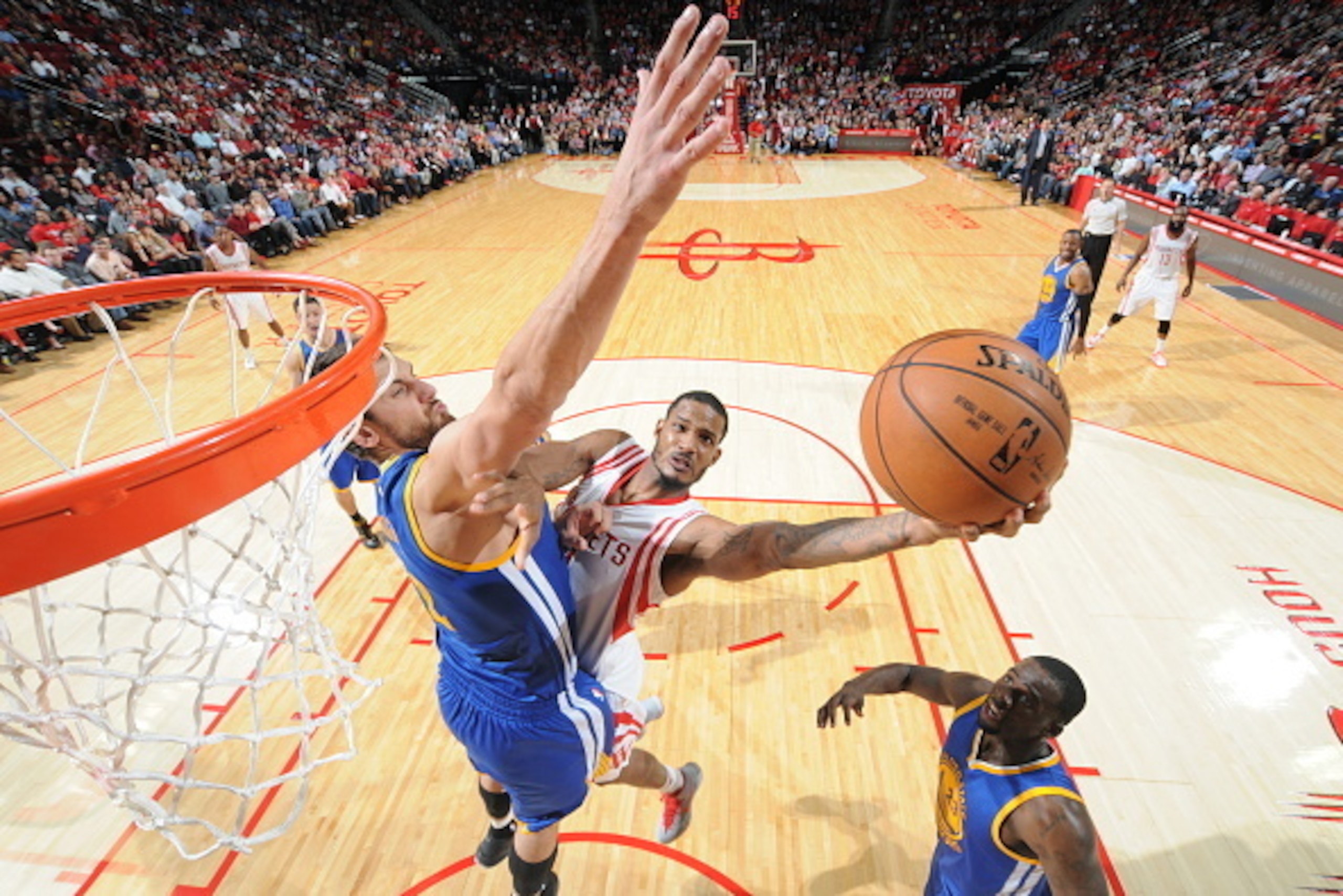HOUSTON, TX - NOVEMBER 8: Trevor Ariza #1 of the Houston Rockets shoots the ball against Andrew Bogut #12 of the Golden State Warriors during the game on November 8, 2014 at the Toyota Center in Houston, Texas. NOTE TO USER: User expressly acknowledges a HOUSTON, TX - NOVEMBER 8: Trevor Ariza #1 of the Houston Rockets shoots the ball against Andrew Bogut #12 of the Golden State Warriors during the game on November 8, 2014 at the Toyota Center in Houston, Texas. NOTE TO USER: User expressly acknowledges a