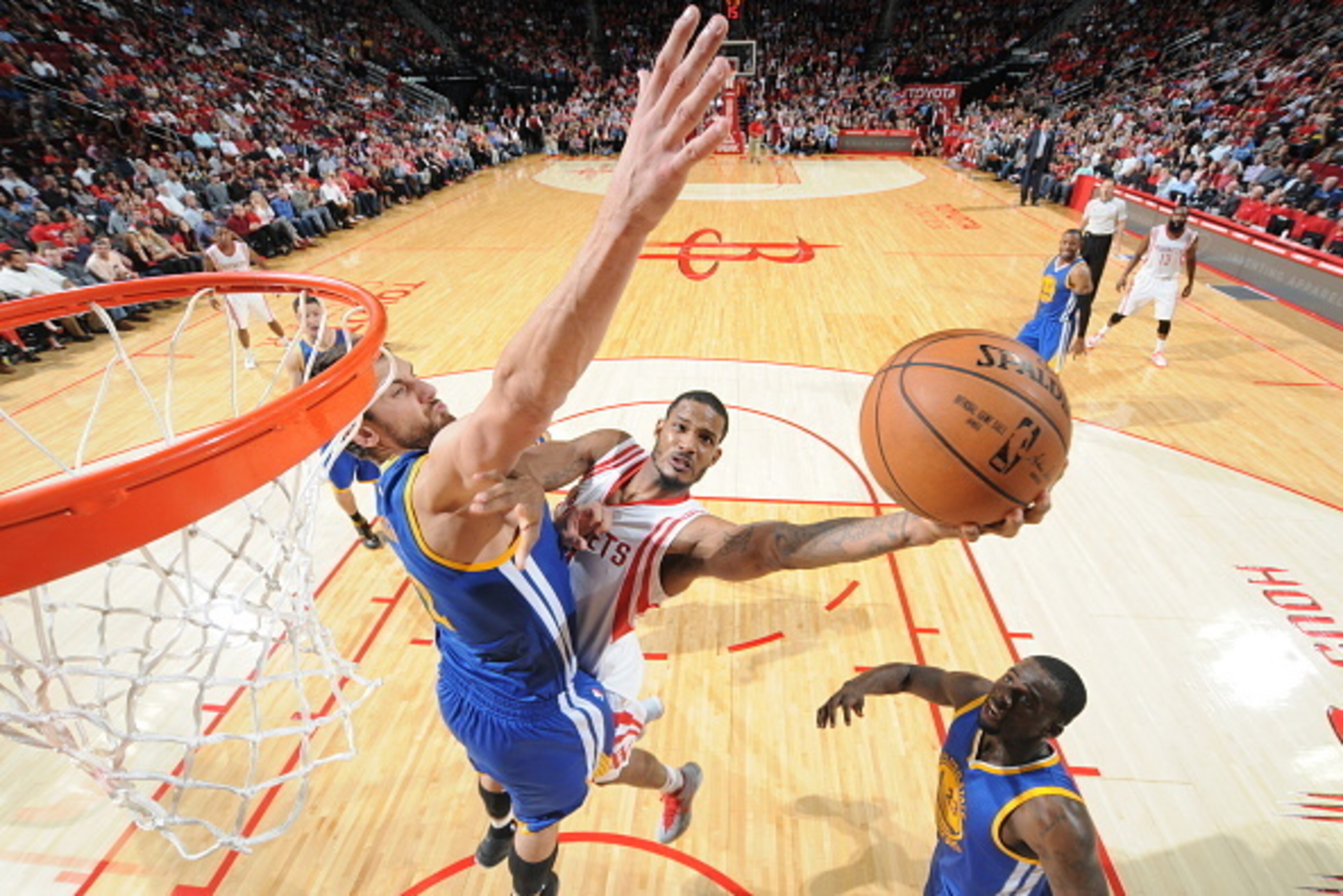 HOUSTON, TX - NOVEMBER 8: Trevor Ariza #1 of the Houston Rockets shoots the ball against Andrew Bogut #12 of the Golden State Warriors during the game on November 8, 2014 at the Toyota Center in Houston, Texas. NOTE TO USER: User expressly acknowledges a HOUSTON, TX - NOVEMBER 8: Trevor Ariza #1 of the Houston Rockets shoots the ball against Andrew Bogut #12 of the Golden State Warriors during the game on November 8, 2014 at the Toyota Center in Houston, Texas. NOTE TO USER: User expressly acknowledges a