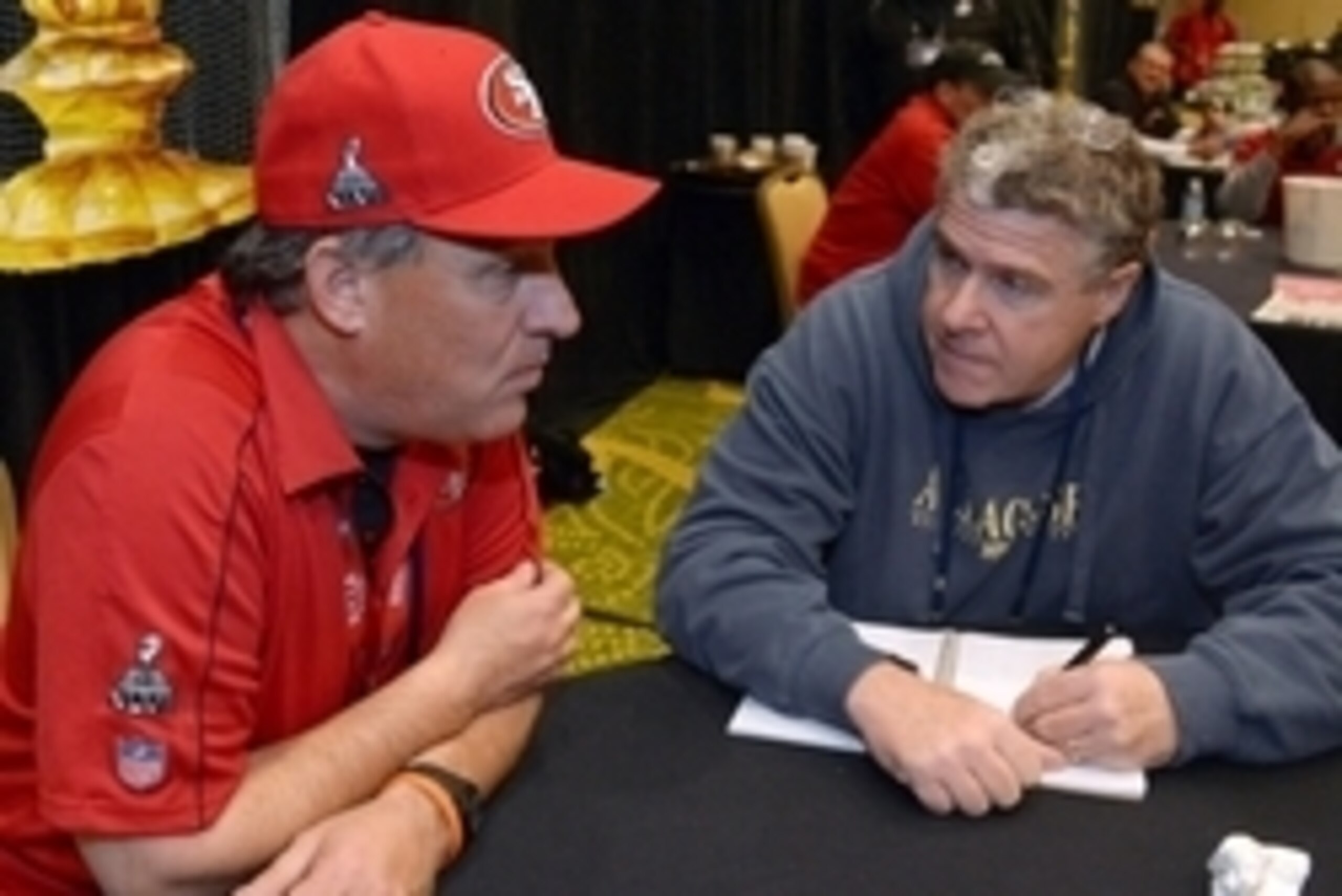 Jan 30, 2013; New Orleans, LA, USA; Sports Illustrated columnist Peter King (right) interviews San Francisco 49ers defensive coordinator Vic Fangio at a press conference at the Marriott New Orleans in advance of Super Bowl XLVII against the Baltimore Rave