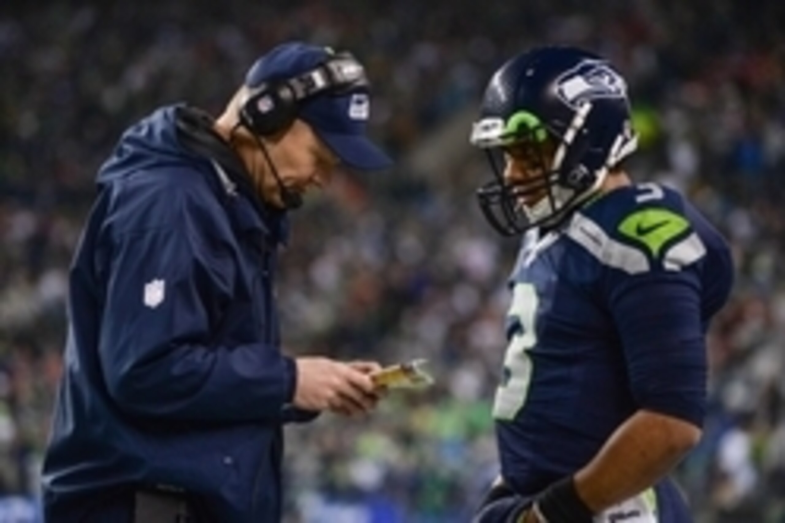 Jan 19, 2014; Seattle, WA, USA; Seattle Seahawks offensive coordinator Darrell Bevell (left) talks to quarterback Russell Wilson (3) during the second half of the 2013 NFC Championship football game against the San Francisco 49ers at CenturyLink Field. Th