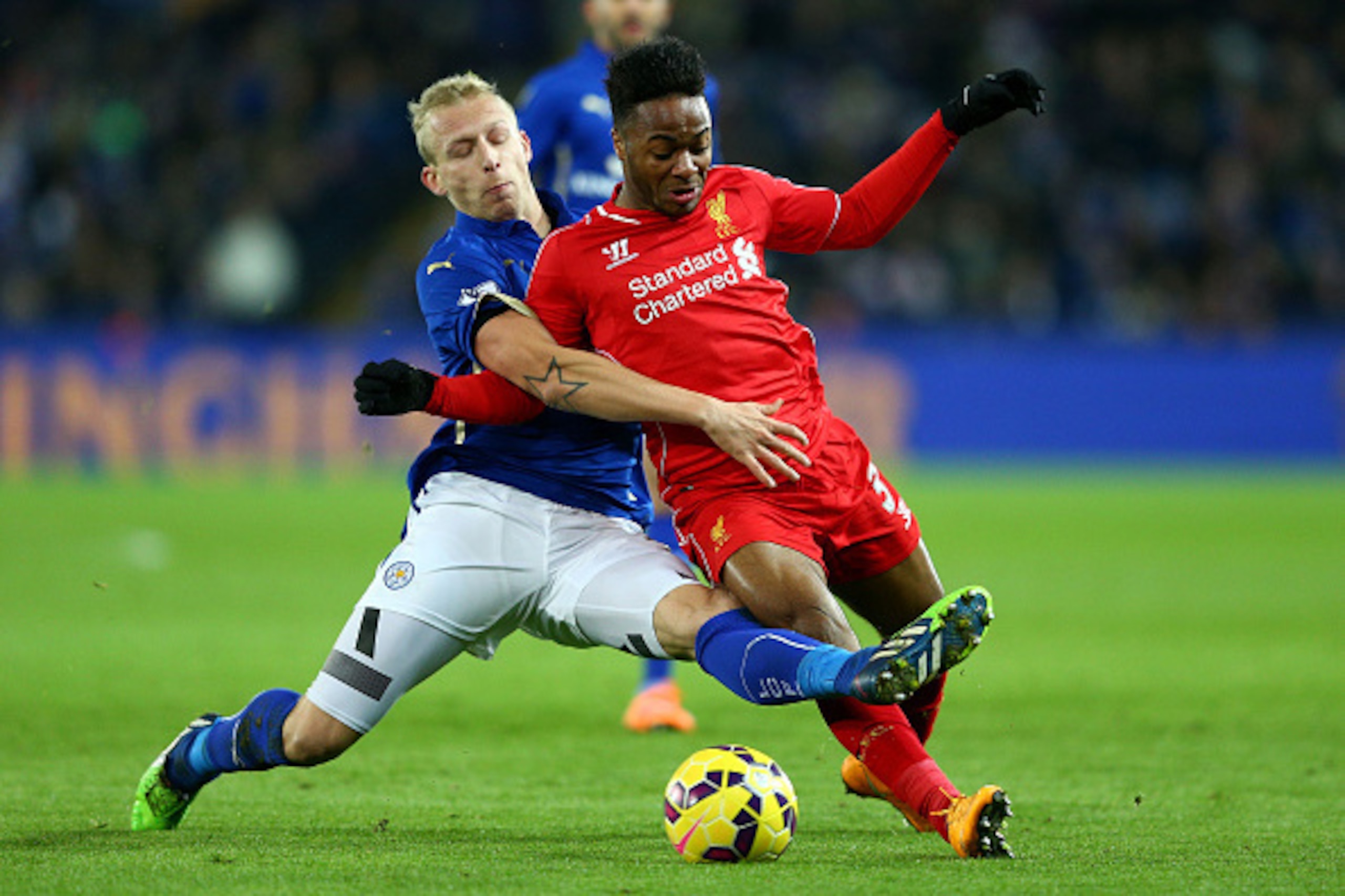 LEICESTER, ENGLAND - DECEMBER 02:  Raheem Sterling of Liverpool is tackled by Ritchie De Laet of Leicester City during the Barclays Premier League match between Leicester City and Liverpool at The King Power Stadium on December 2, 2014 in Leicester, Engla