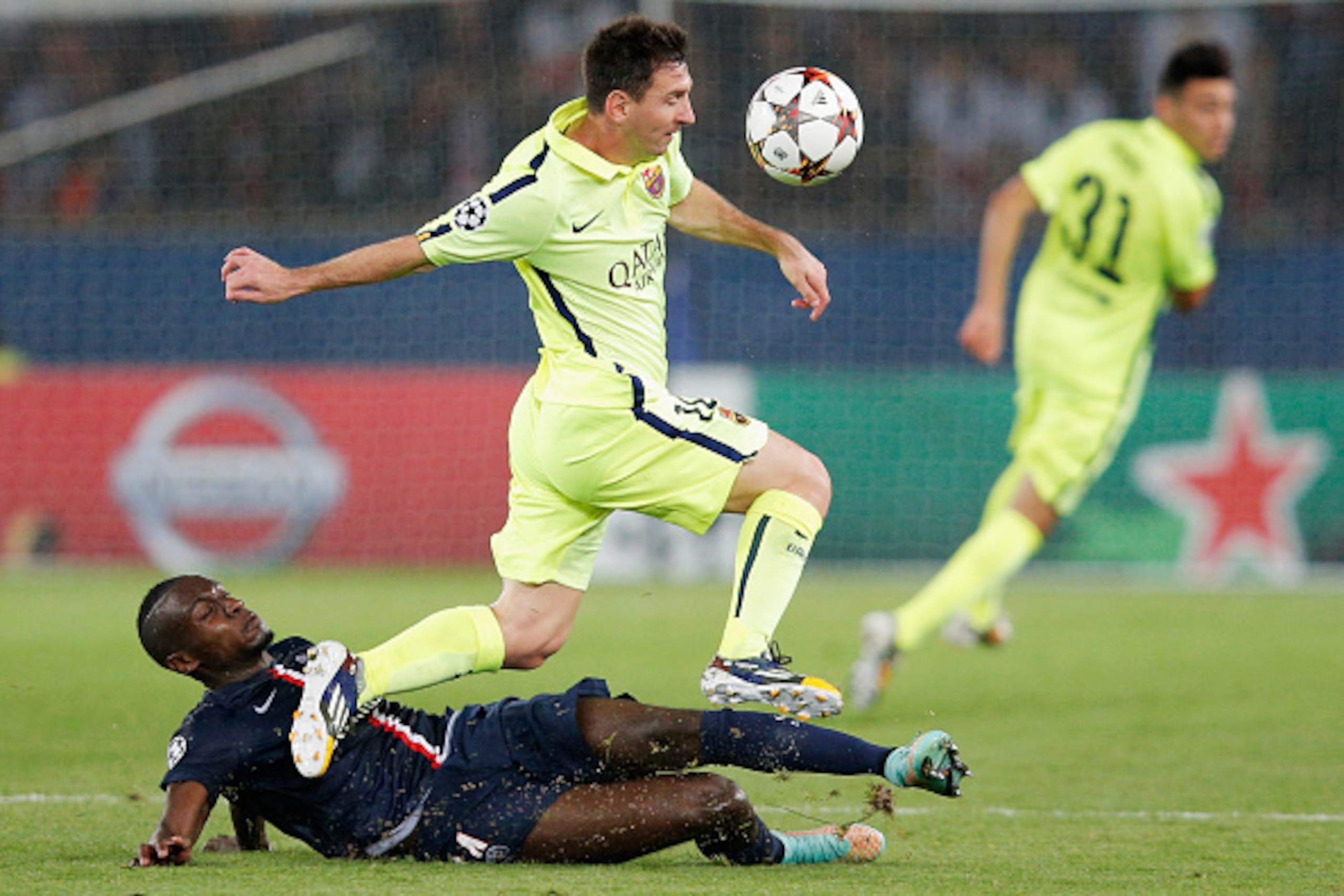 PARIS, FRANCE - SEPTEMBER 30:   Lionel Messi of Barcelona skips the takle from Blaise Matuidi of PSG during the Group F UEFA Champions League match between Paris Saint-Germain v FC Barcelona held at Parc des Princes on September 30, 2014 in Paris, France.