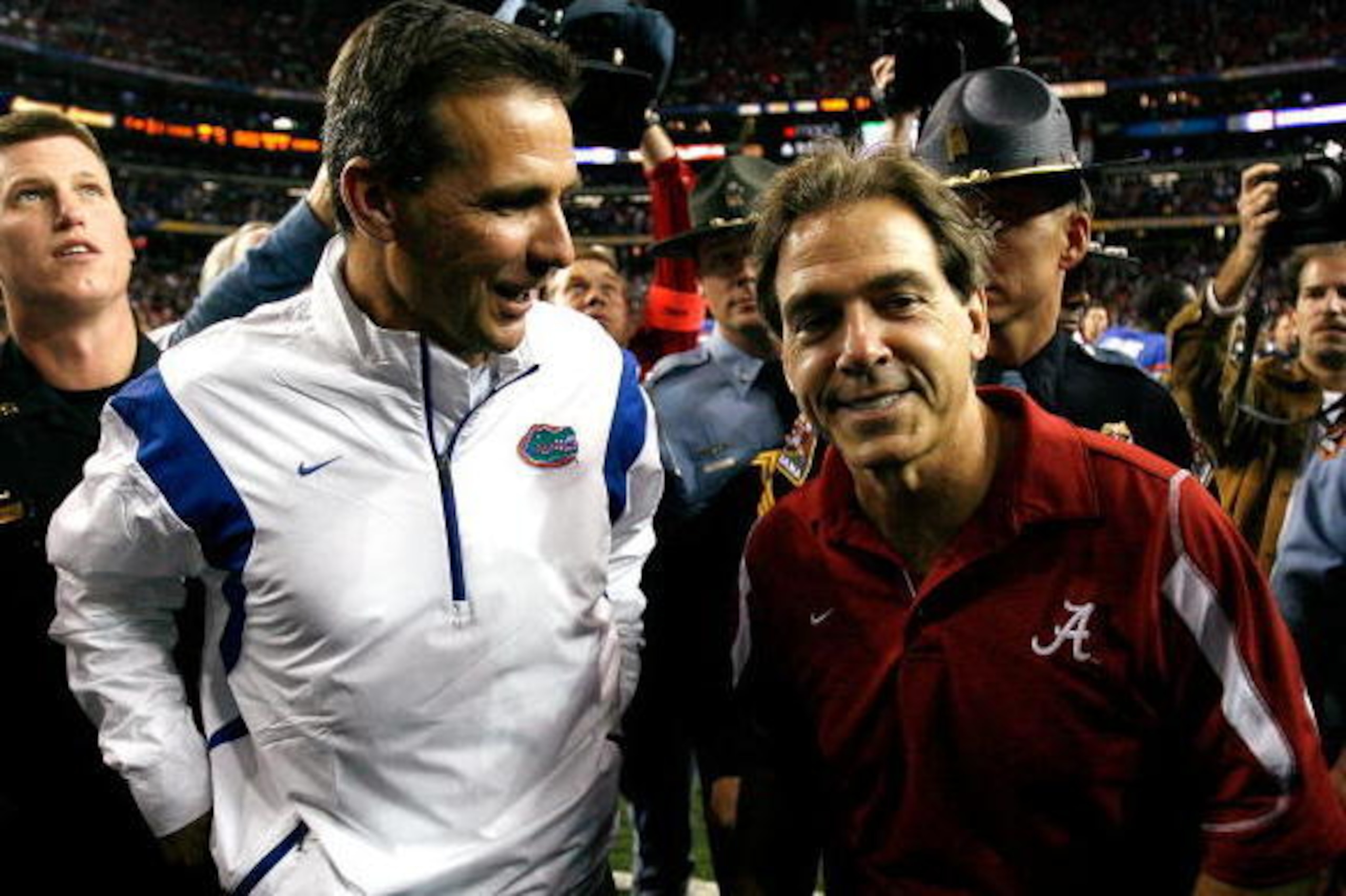 ATLANTA - DECEMBER 06:  Head coach Nick Saban of the Alabama Crimson Tide congratulates head coach Urban Meyer of the Florida Gators after the Gators 31-20 win in the SEC Championship on December 6, 2008 at the Georgia Dome in Atlanta, Georgia.  (Photo by