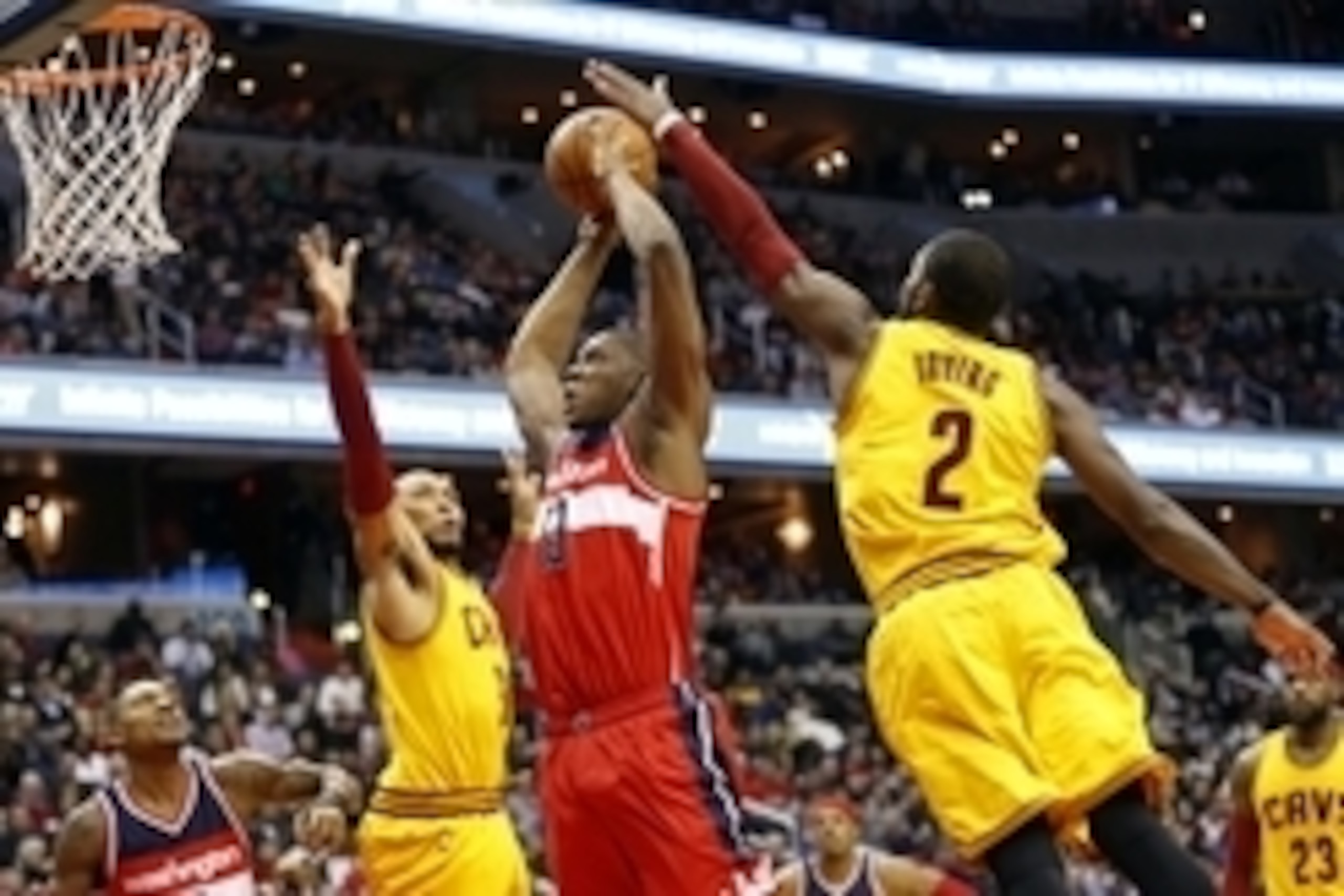 Nov 21, 2014; Washington, DC, USA; Washington Wizards center Kevin Seraphin (13) attempts to dunk the ball as Cleveland Cavaliers guard Kyrie Irving (2) and Cavaliers forward Shawn Marion (31) defend in the second quarter at Verizon Center. The Wizards wo