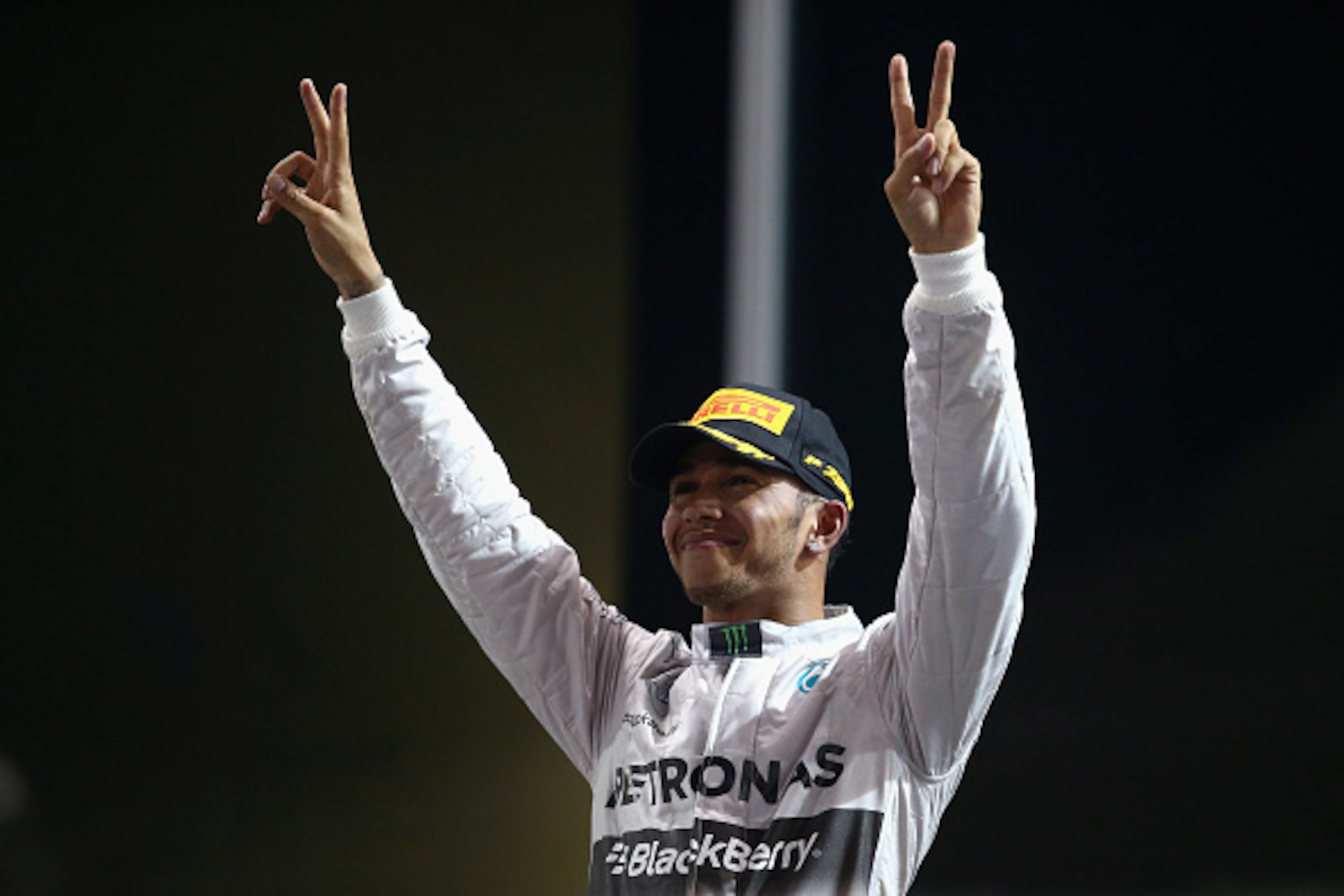 ABU DHABI, UNITED ARAB EMIRATES - NOVEMBER 23:  Lewis Hamilton of Great Britain and Mercedes GP celebrates on the podium after winning the World Championship and the Abu Dhabi Formula One Grand Prix at Yas Marina Circuit on November 23, 2014 in Abu Dhabi,