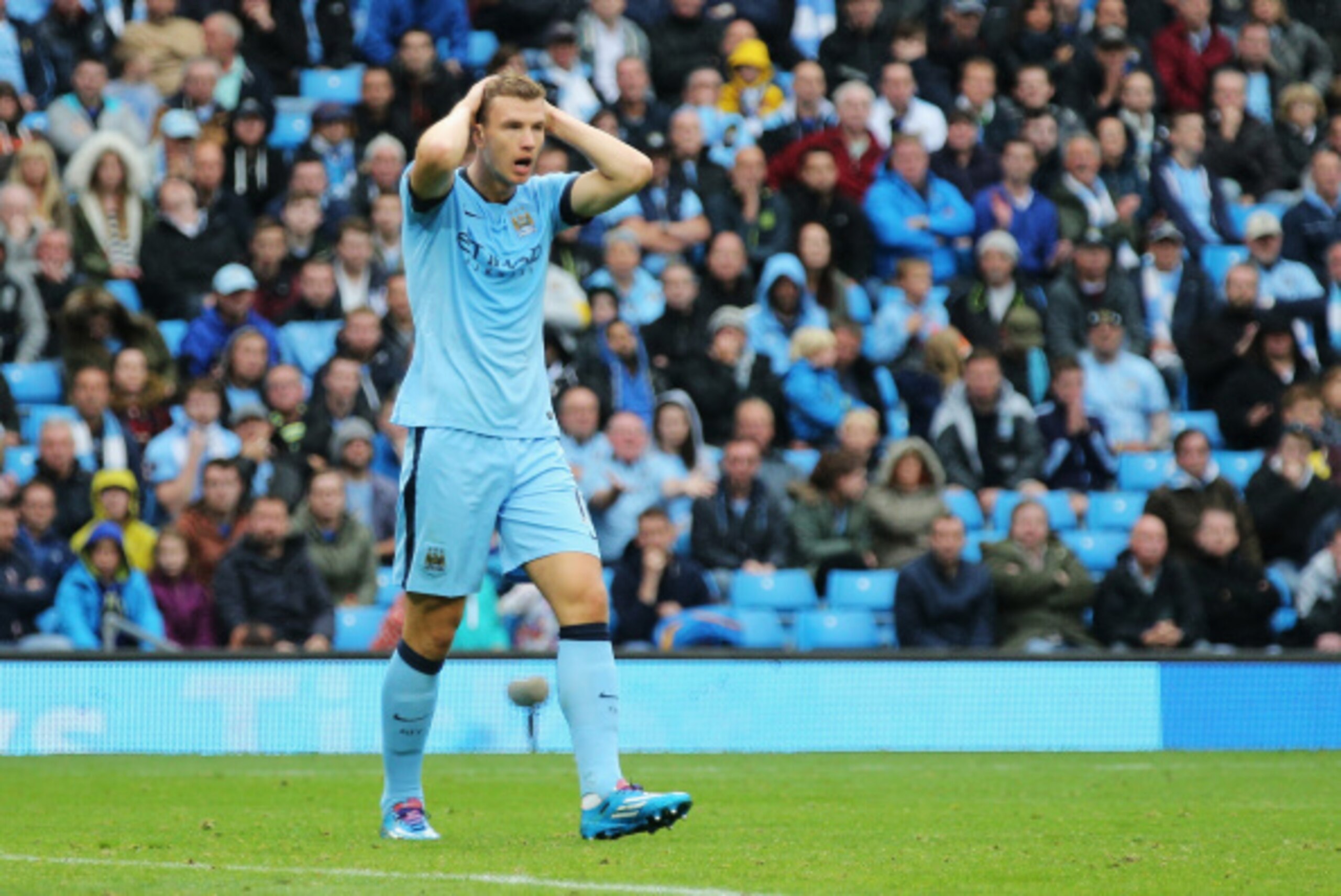 MANCHESTER, ENGLAND - AUGUST 30: Edin Dzeko of Manchester City reacts during the Barclays Premier League match between Manchester City and Stoke City at Etihad Stadium on August 30, 2014 in Manchester, England.  (Photo by Clive Mason/Getty Images)