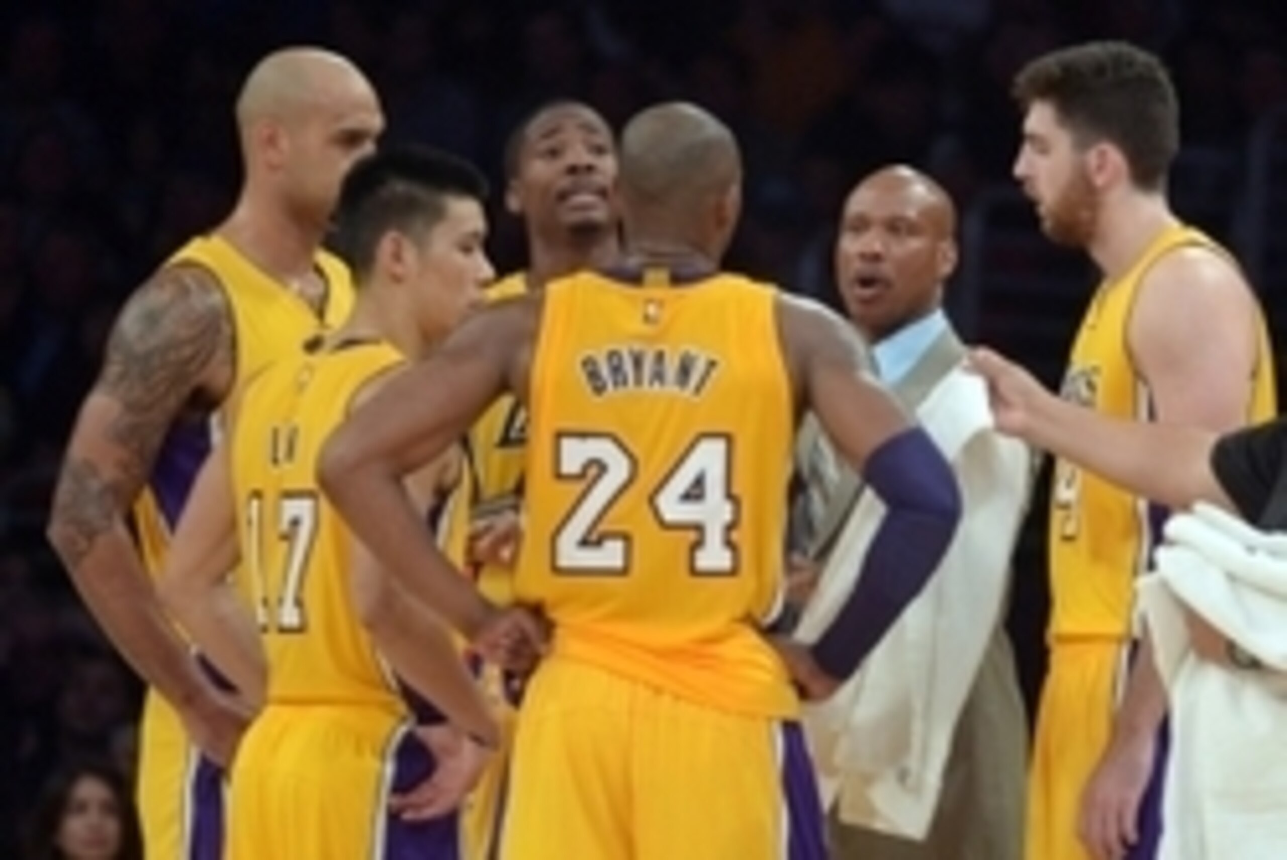 Nov 14, 2014; Los Angeles, CA, USA; Los Angeles Lakers coach Byron Scott (second from right) huddles with Robert Sacre (50), Jeremy Lin (17), Ed Davis (21), Kobe Bryant (24) and Ryan Kelly (4) against the San Antonio Spurs at Staples Center. The Spurs def