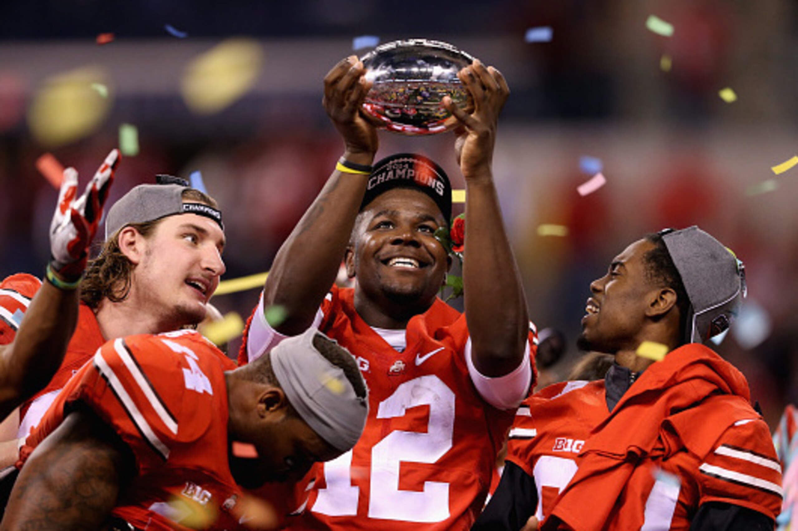 INDIANAPOLIS, IN - DECEMBER 06:  Quarterback Cardale Jones #12 of the Ohio State Buckeyes lifts the Big Ten trophy after his team defeeated the Wisconsin Badgers 59-0 in the Big Ten Championship at Lucas Oil Stadium on December 6, 2014 in Indianapolis, In