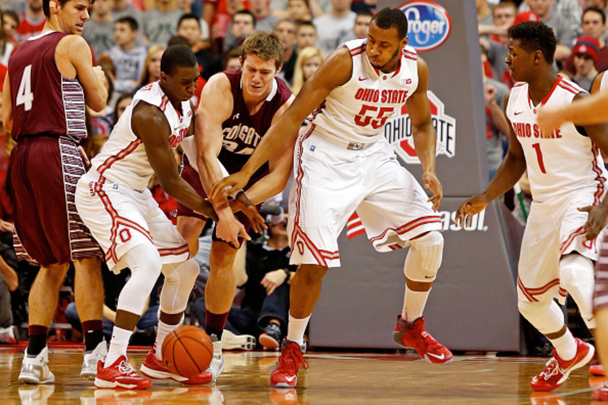 COLUMBUS, OH - DECEMBER 6:  Shannon Scott #3 and Trey McDonald #55 of the Ohio State Buckeyes attempt to keep John Fenton #34 of the Colgate Raiders from gaining control of a loose ball during the second half at Value City Arena on December 6, 2014 in Col