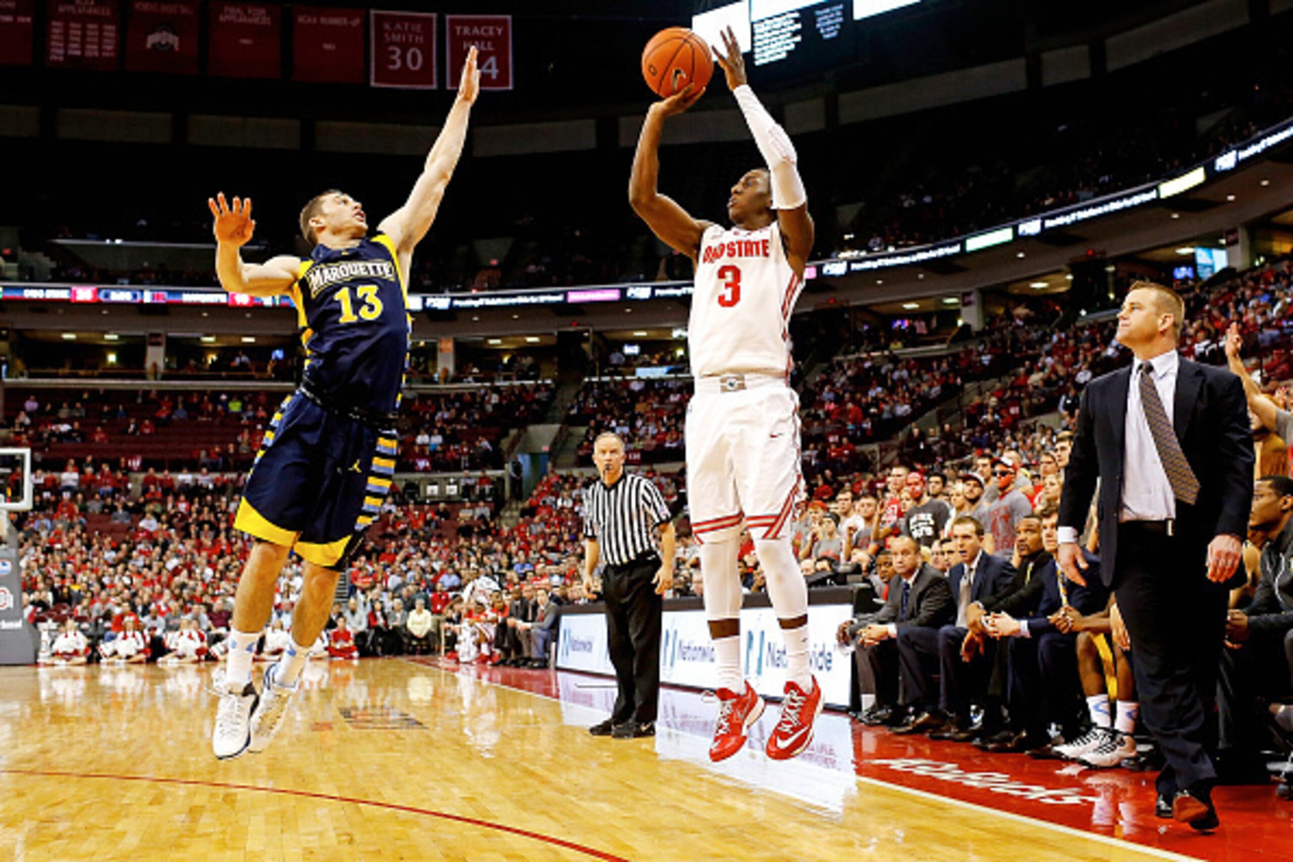 COLUMBUS, OH - NOVEMBER 18:  Shannon Scott #3 of the Ohio State Buckeyes shoots a three point shot over Matt Carlino #13 of the Marquette Golden Eagles during the first half at Value City Arena on November 18, 2014 in Columbus, Ohio. (Photo by Kirk Irwin/