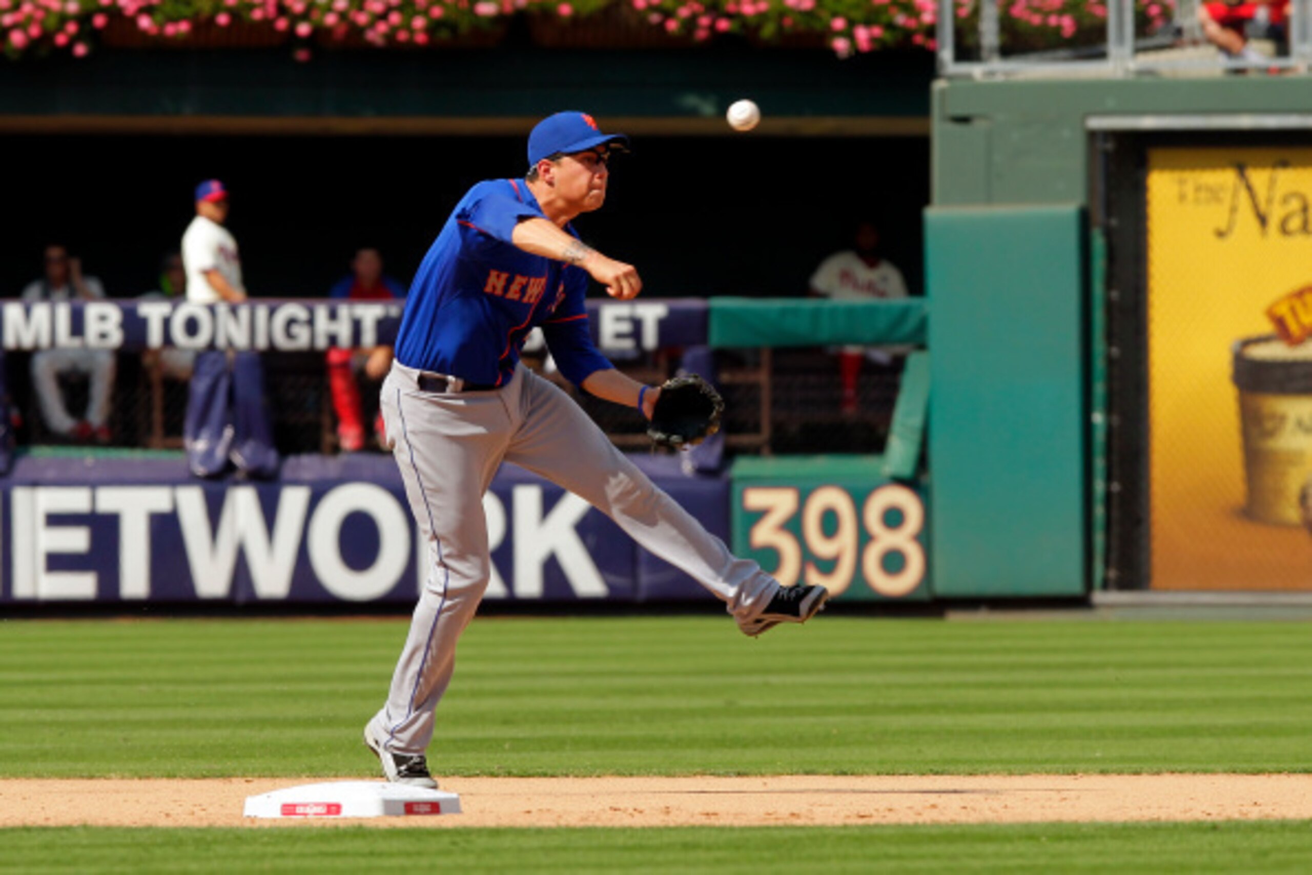 PHILADELPHIA - AUGUST 10: Wilmer Flores #4 of the New York Mets throws to first base after fielding a ground ball during a game against the Philadelphia Phillies at Citizens Bank Park on August 10, 2014 in Philadelphia, Pennsylvania. The Phillies won 7-6.