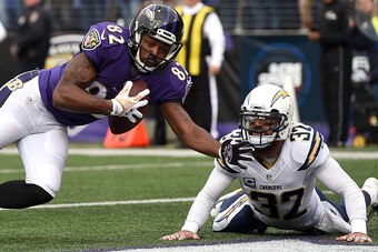 BALTIMORE, MD - NOVEMBER 30: Wide receiver Torrey Smith #82 of the Baltimore Ravens scores a touchdown in front of free safety Eric Weddle #32 of the San Diego Chargers in the first quarter at M&T Bank Stadium on November 30, 2014 in Baltimore, Maryland. 