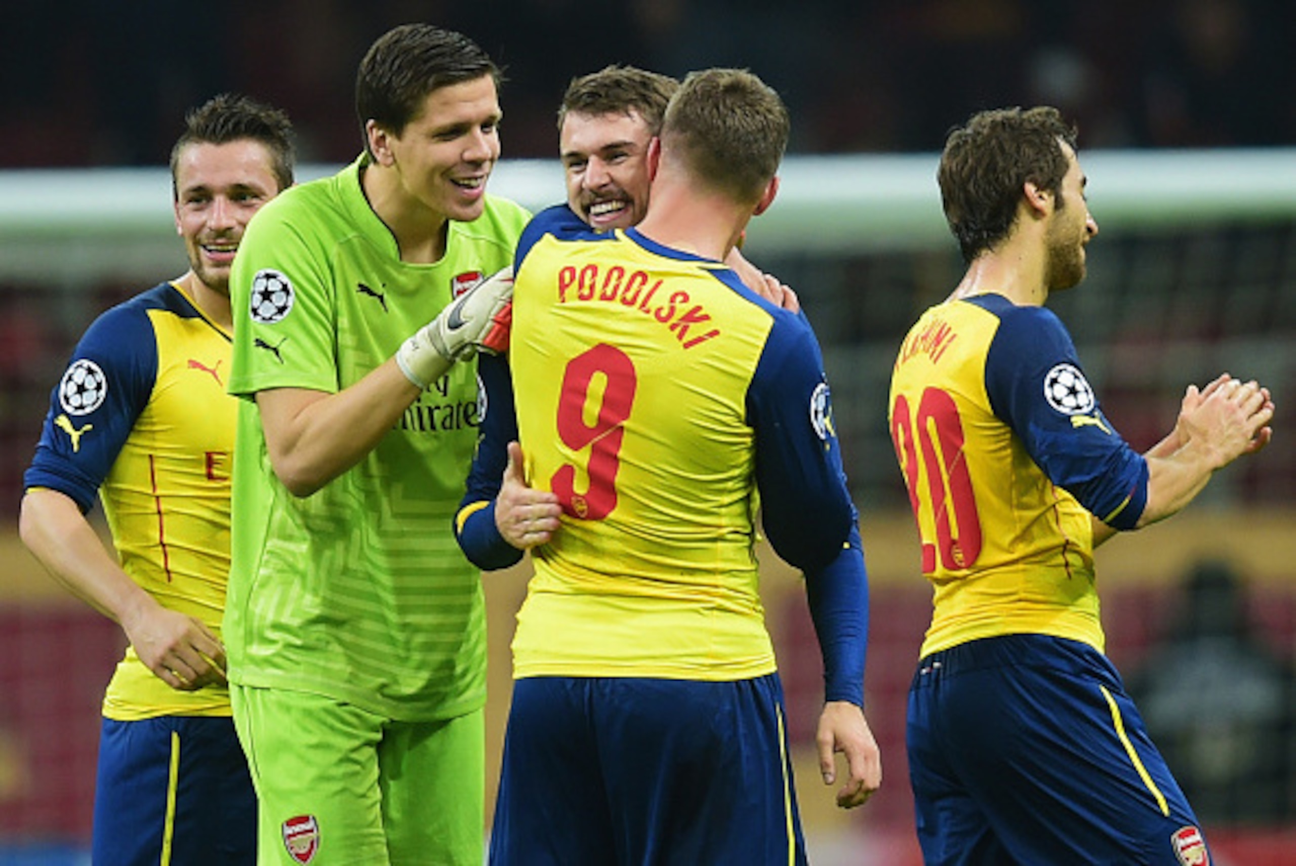 ISTANBUL, TURKEY - DECEMBER 09:  Aaron Ramsey of Arsenal (3L) celebrates with team mates Wojciech Szczesny (2L) and Lukas Podolski (9) as he scores their third goal during the UEFA Champions League Group D match between Galatasaray AS and Arsenal FC at Al
