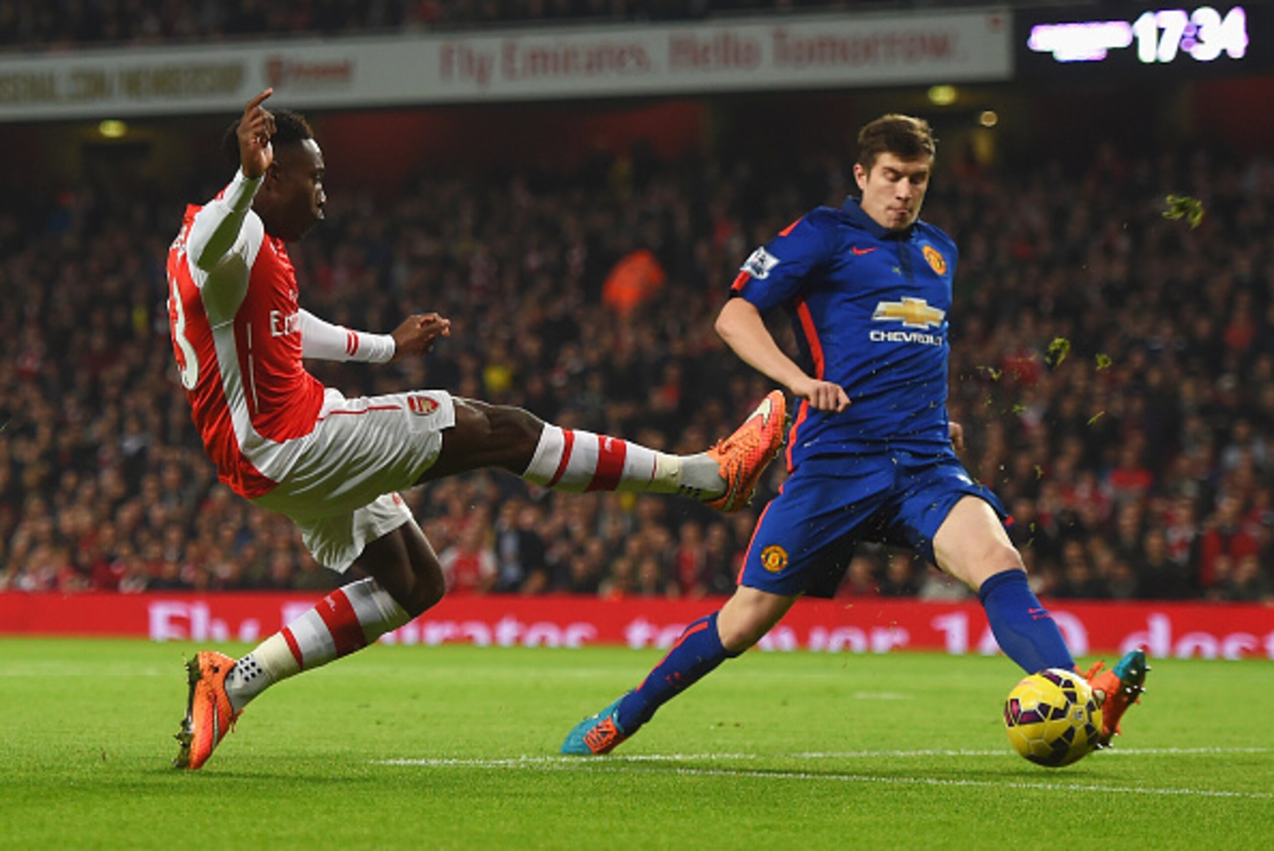 LONDON, ENGLAND - NOVEMBER 22: Danny Welbeck of Arsenal misses from close range under pressure from Paddy McNair of Manchester United during the Barclays Premier League match between Arsenal and Manchester United at Emirates Stadium on November 22, 2014 i