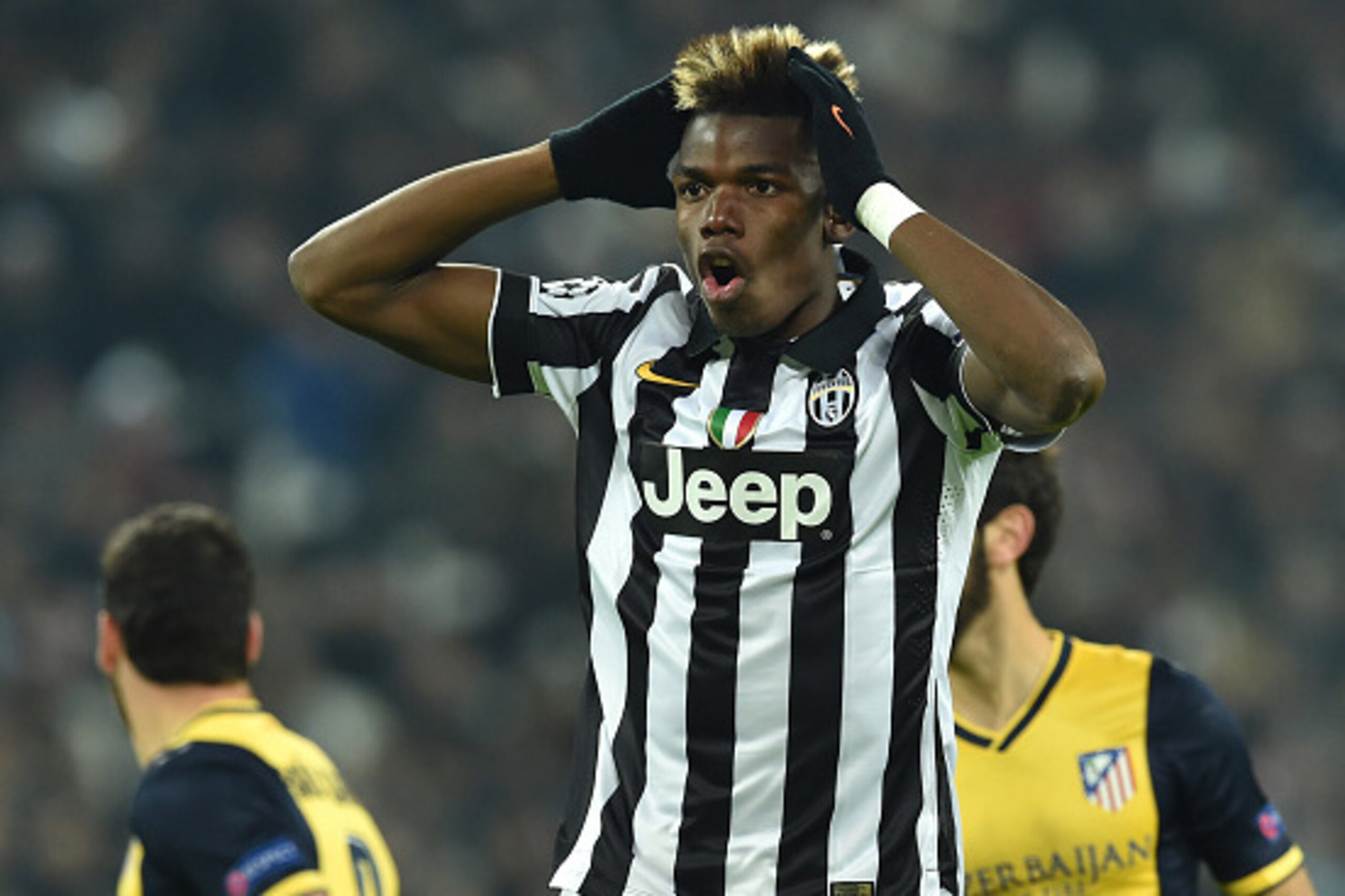 TURIN, ITALY - DECEMBER 09:  Paul Pogba of Juventus reacts during the UEFA Champions League group A match between Juventus and Club Atletico de Madrid at Juventus Arena on December 9, 2014 in Turin, Italy.  (Photo by Valerio Pennicino/Getty Images)