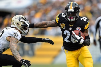 PITTSBURGH, PA - NOVEMBER 30:  Le'Veon Bell #26 of the Pittsburgh Steelers stiff arms Kenny Vaccaro #32 of the New Orleans Saints during the first quarter at Heinz Field on November 30, 2014 in Pittsburgh, Pennsylvania.  (Photo by Joe Sargent/Getty Images