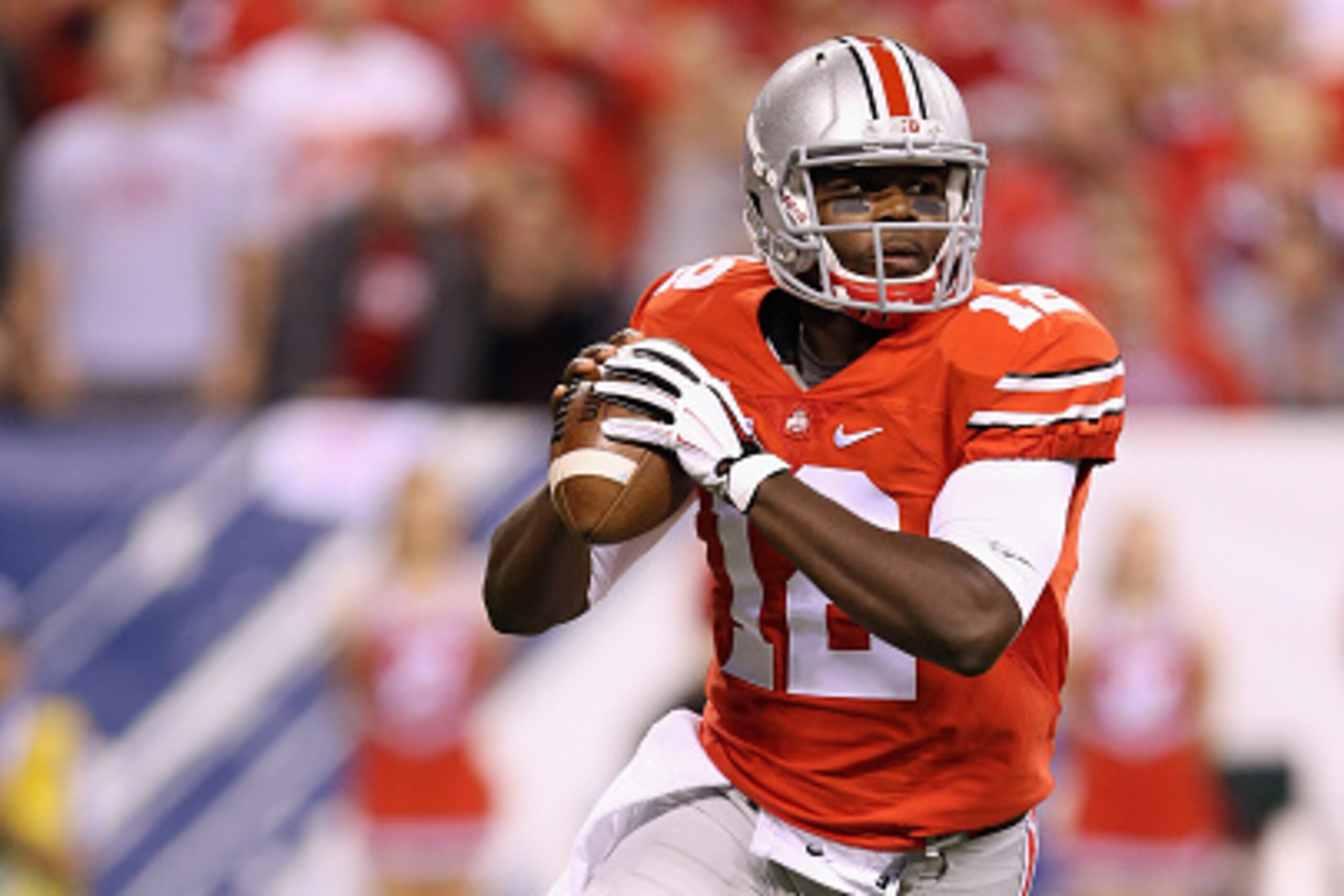 INDIANAPOLIS, IN - DECEMBER 06:  Quarterback Cardale Jones #12 of the Ohio State Buckeyes sets up in the pocket during the first quarter against the Wisconsin Badgers in the Big Ten Championship at Lucas Oil Stadium on December 6, 2014 in Indianapolis, In