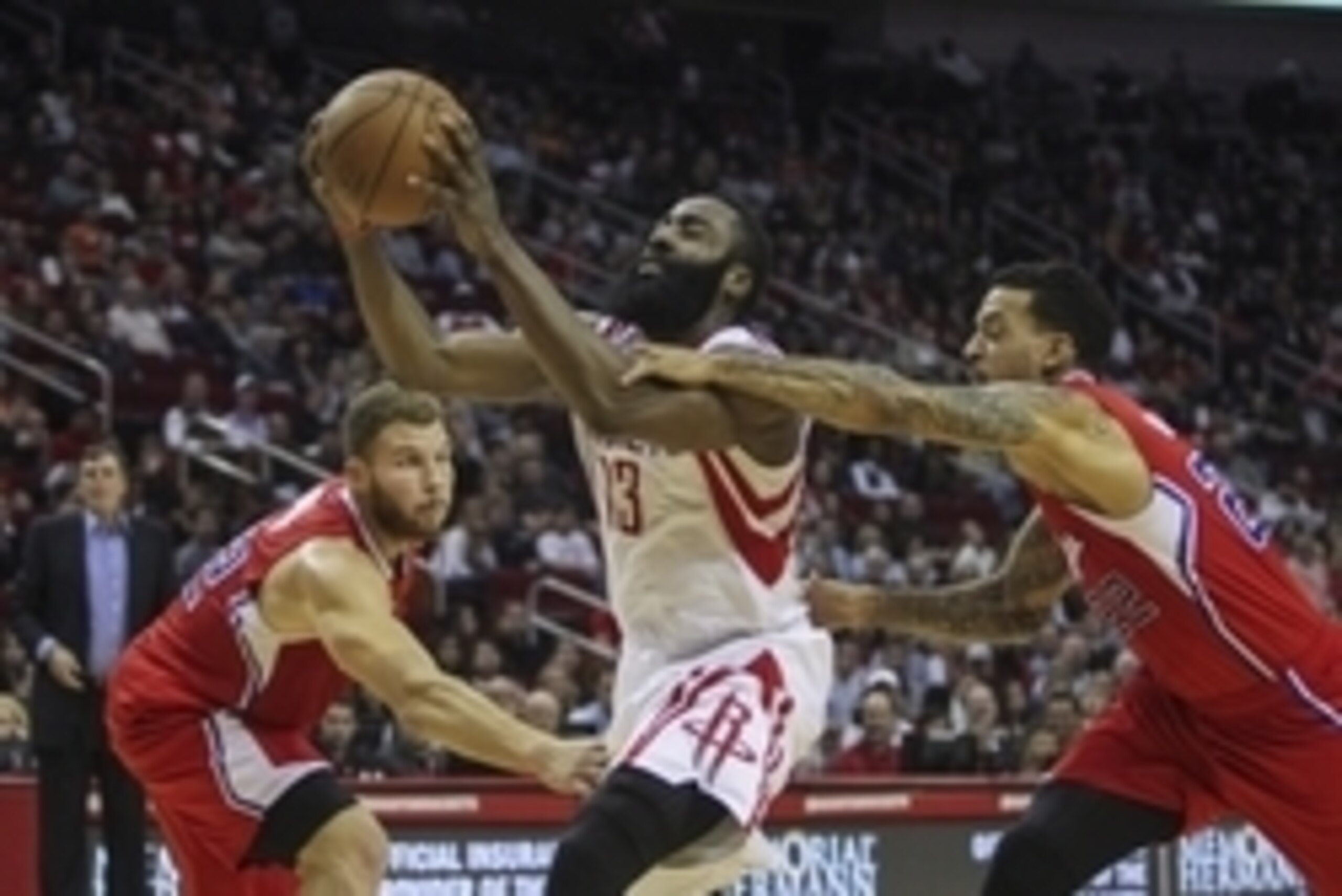 Nov 28, 2014; Houston, TX, USA; Houston Rockets guard James Harden (13) takes the ball to the basket during the second quarter as Los Angeles Clippers forward Blake Griffin (32) and forward Matt Barnes (22) defend at Toyota Center. Mandatory Credit: Troy 
