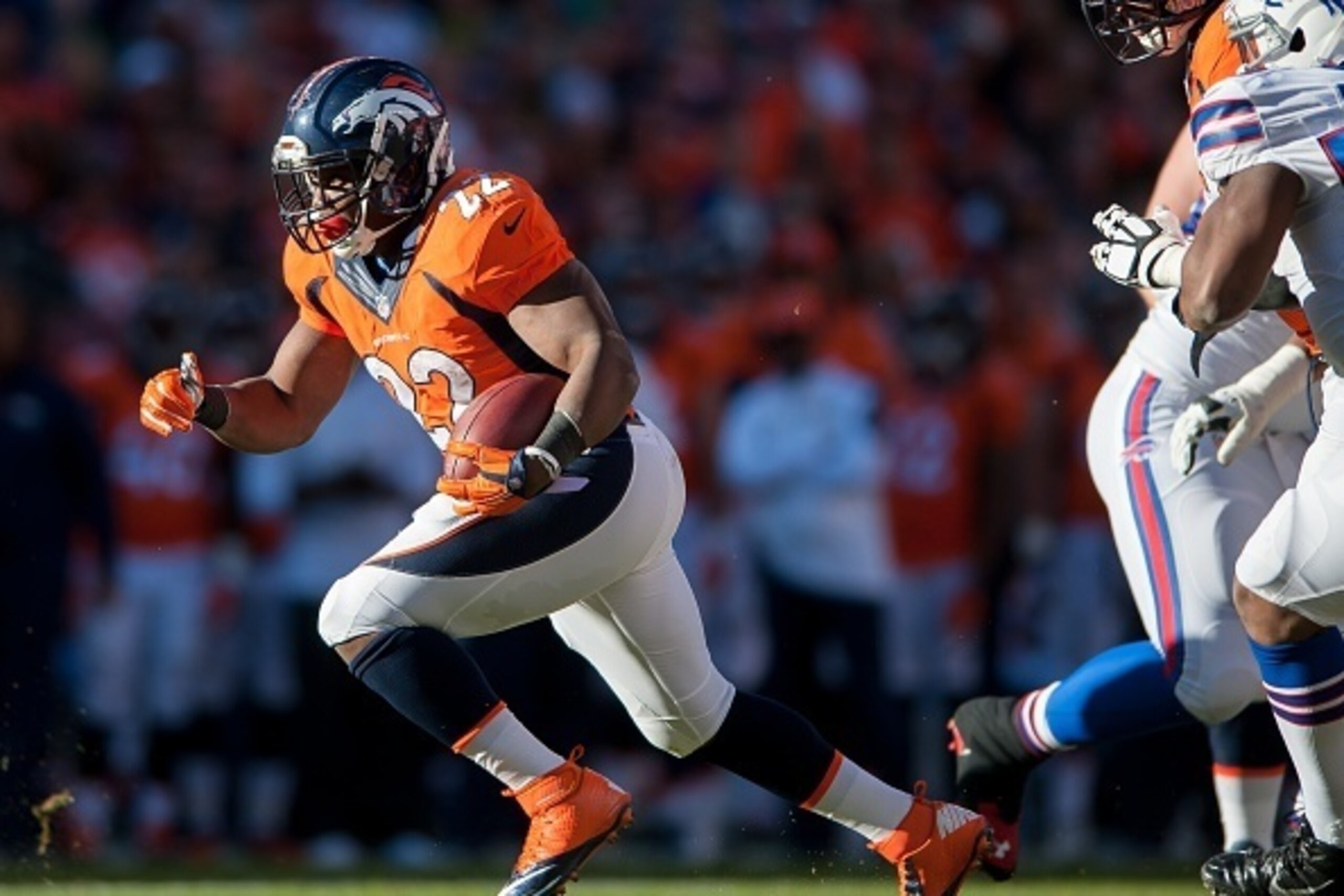 DENVER, CO - DECEMBER 7:  Running back C.J. Anderson #22 of the Denver Broncos rushes for a touchdown against the Denver Broncos at Sports Authority Field at Mile High on December 7, 2014 in Denver, Colorado.  (Photo by Dustin Bradford/Getty Images)