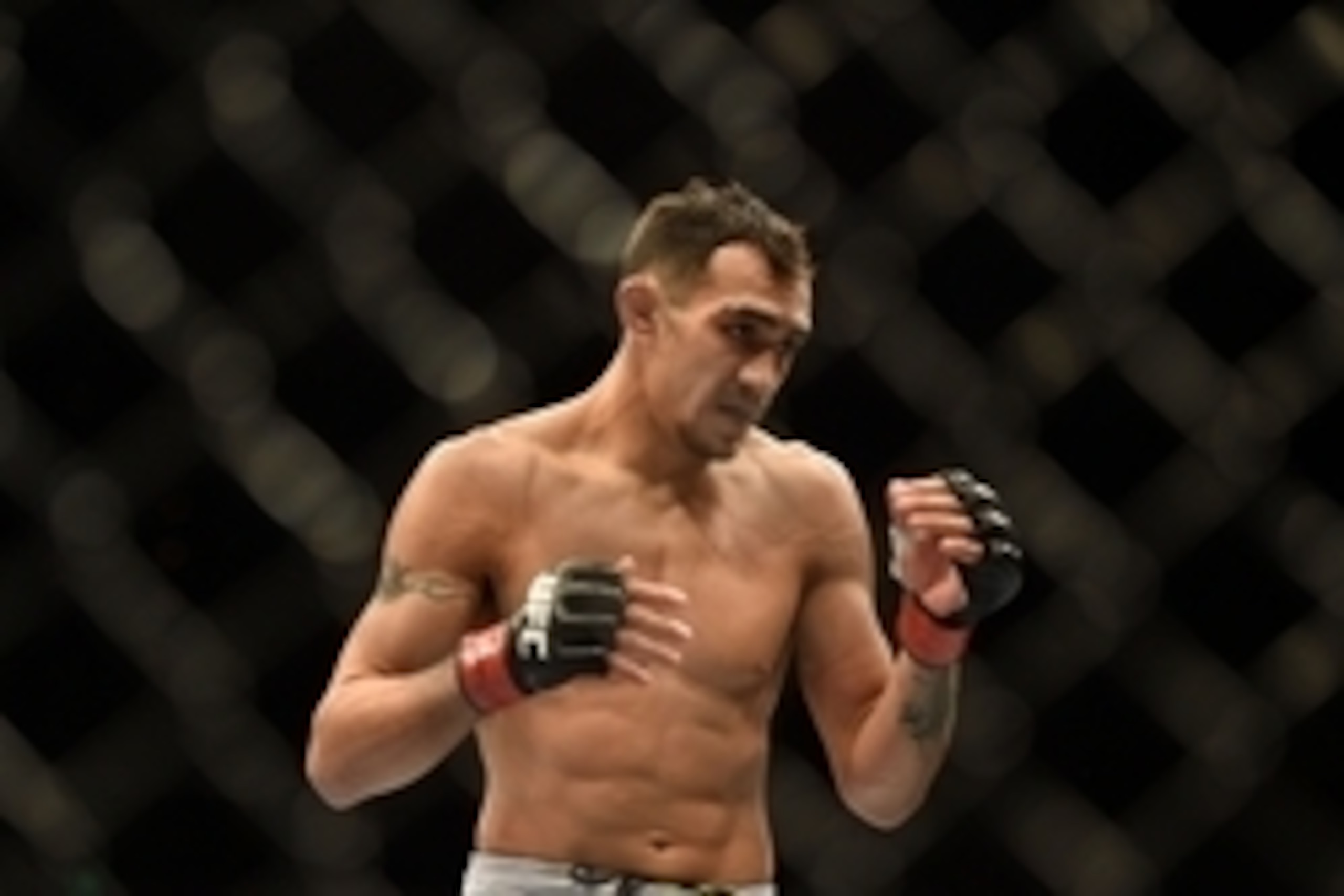 August 30, 2014; Sacramento, CA, USA; Tony Ferguson (red gloves) fights against Danny Castillo (blue gloves) during the lightweight bout of UFC 177 at Sleep Train Arena. Mandatory Credit: Kyle Terada-USA TODAY Sports