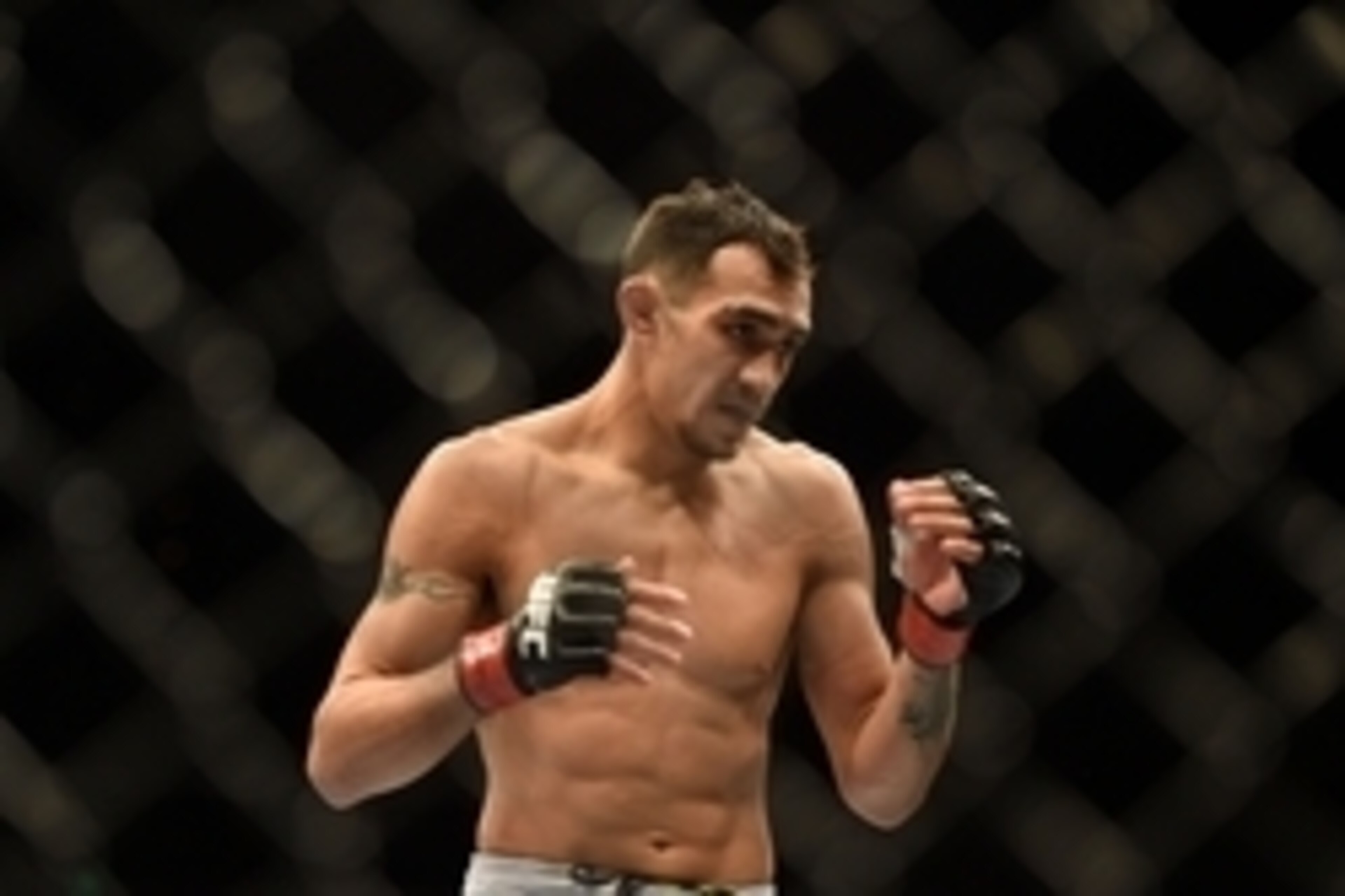 August 30, 2014; Sacramento, CA, USA; Tony Ferguson (red gloves) fights against Danny Castillo (blue gloves) during the lightweight bout of UFC 177 at Sleep Train Arena. Mandatory Credit: Kyle Terada-USA TODAY Sports